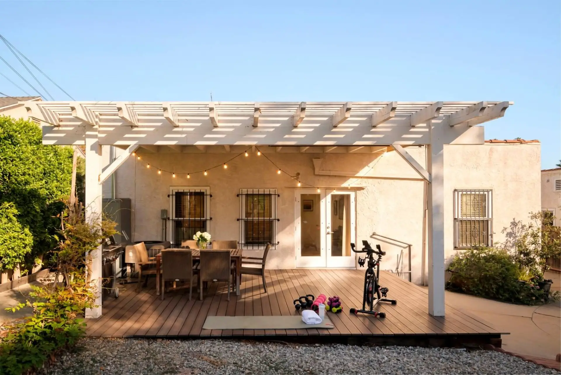 Golden hour dinners under the pergola, string lights on and the grill going