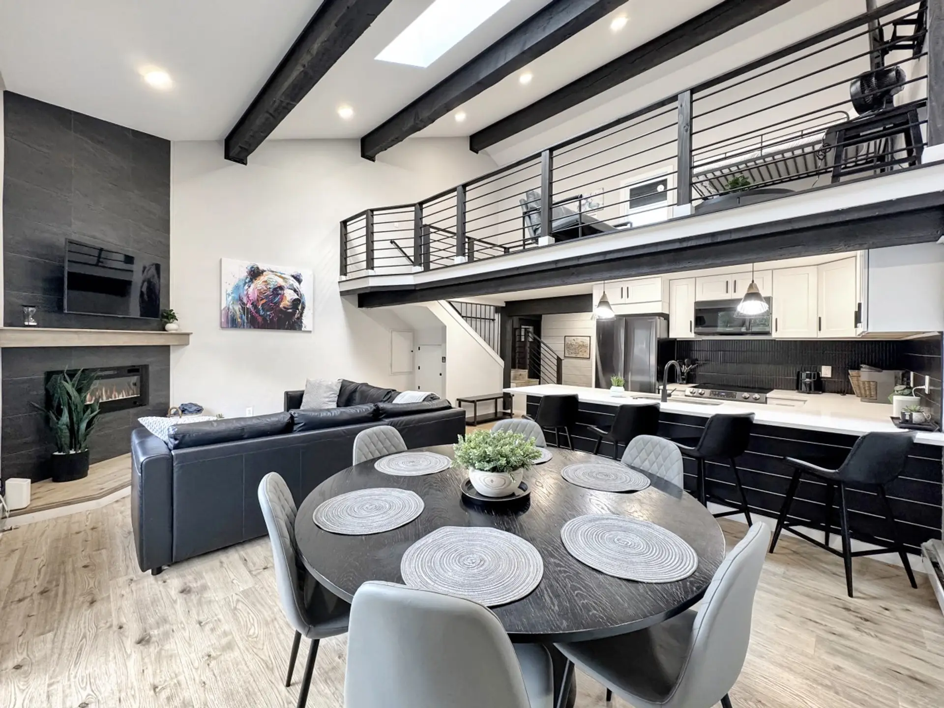 Step inside and the whole condo unfolds before you: open dining, sleek kitchen, cozy living room, and a loft above, all bathed in mountain light. Home base for your Vail ski week