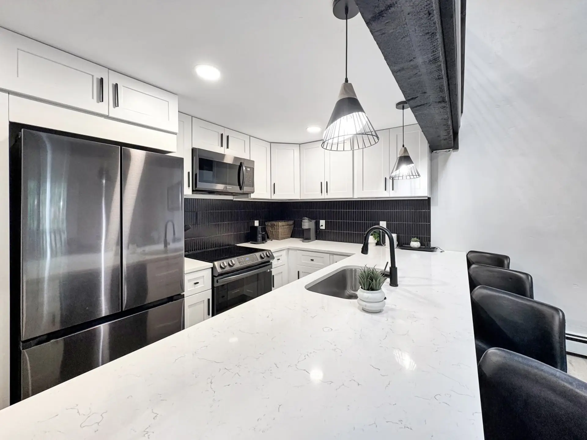 Gather around the island under gleaming countertops while dinner comes together fast: full fridge, electric range, oven, and microwave, all brand new and ready for family meals