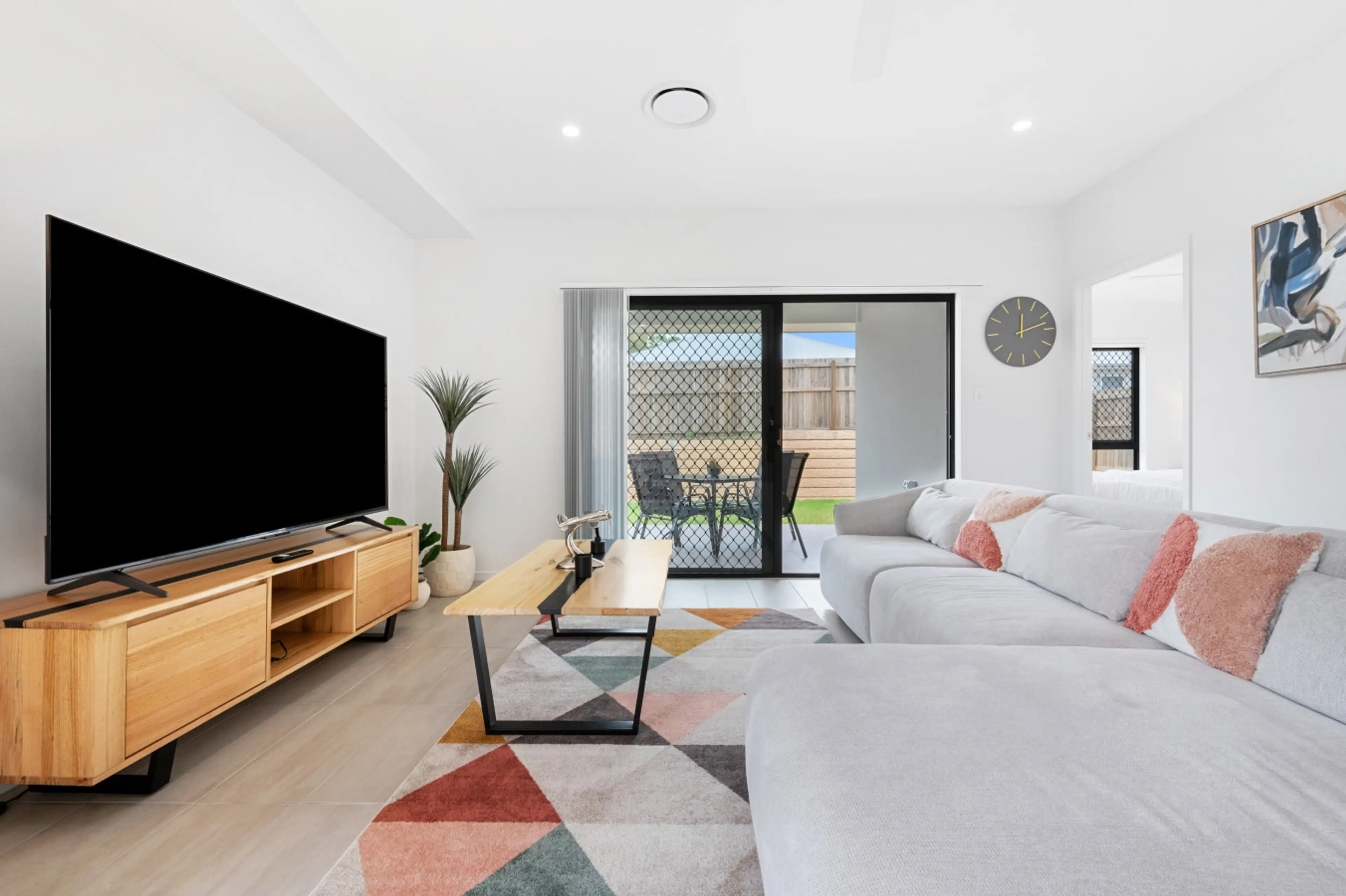 Relax in the family room with a huge 75 inch smart TV.