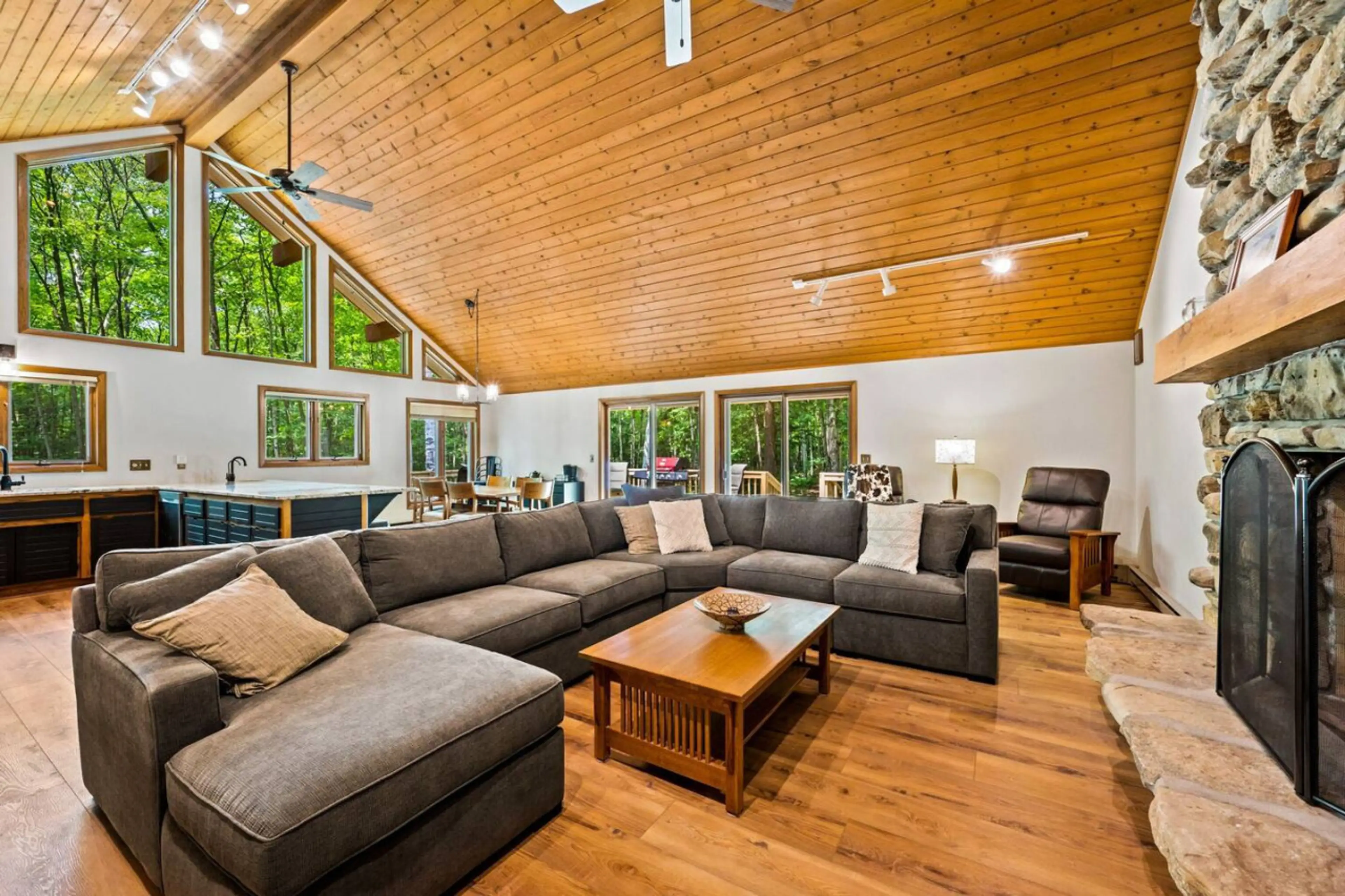Living Room: Expansive windows invite nature inside, perfect for gathering and relaxation!