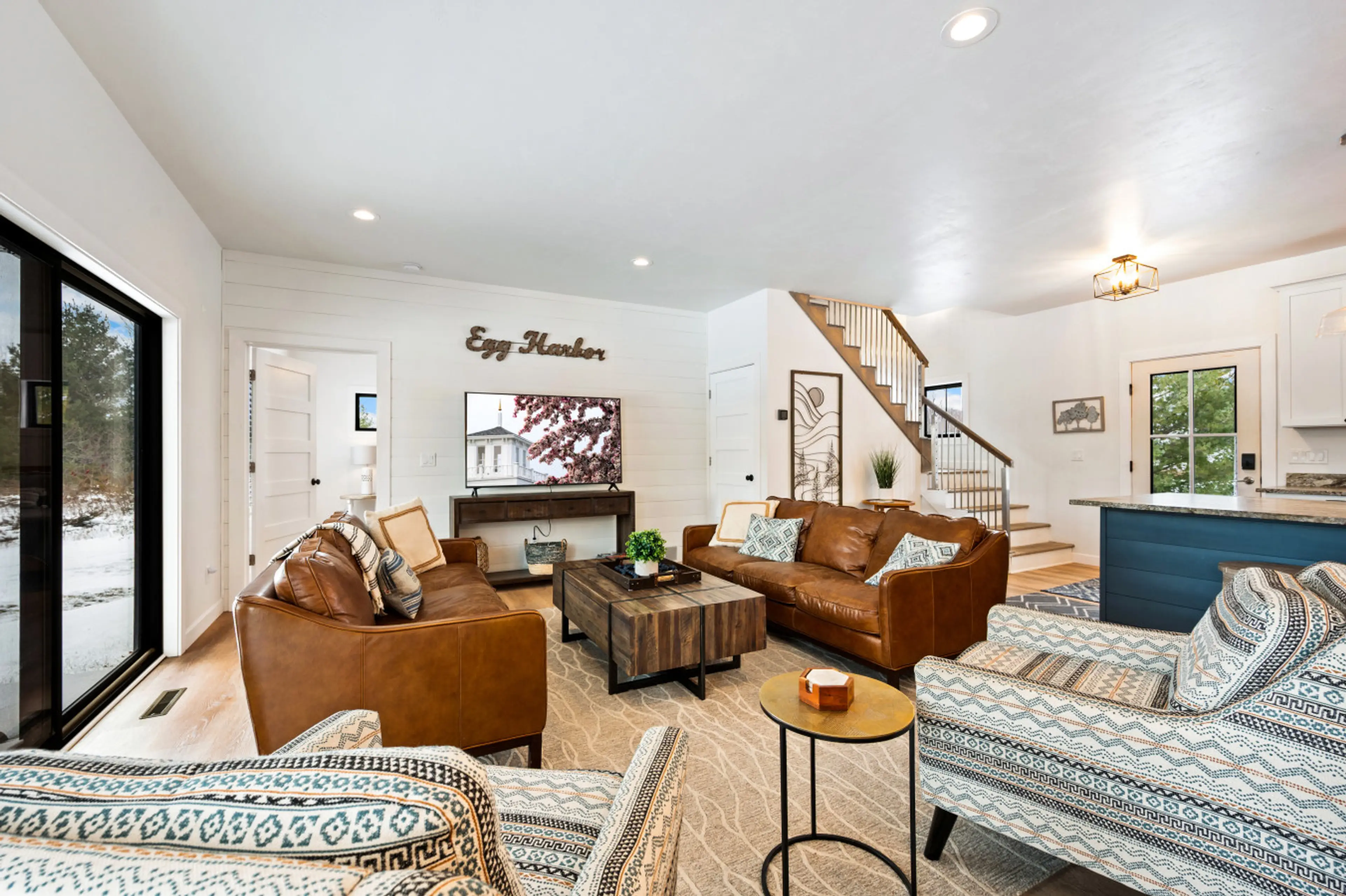Living Room: Bright and airy space with inviting leather sofas and open kitchen views!