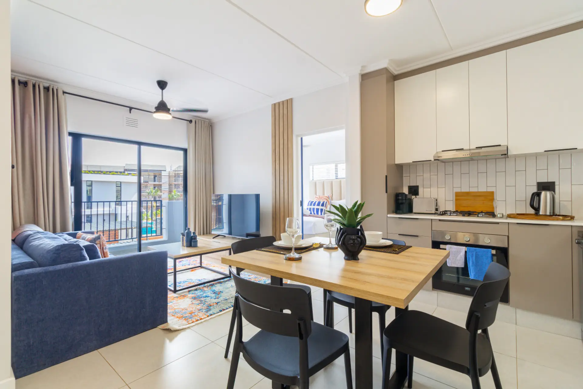 Open-plan living, dining and kitchen area leading out to the balcony