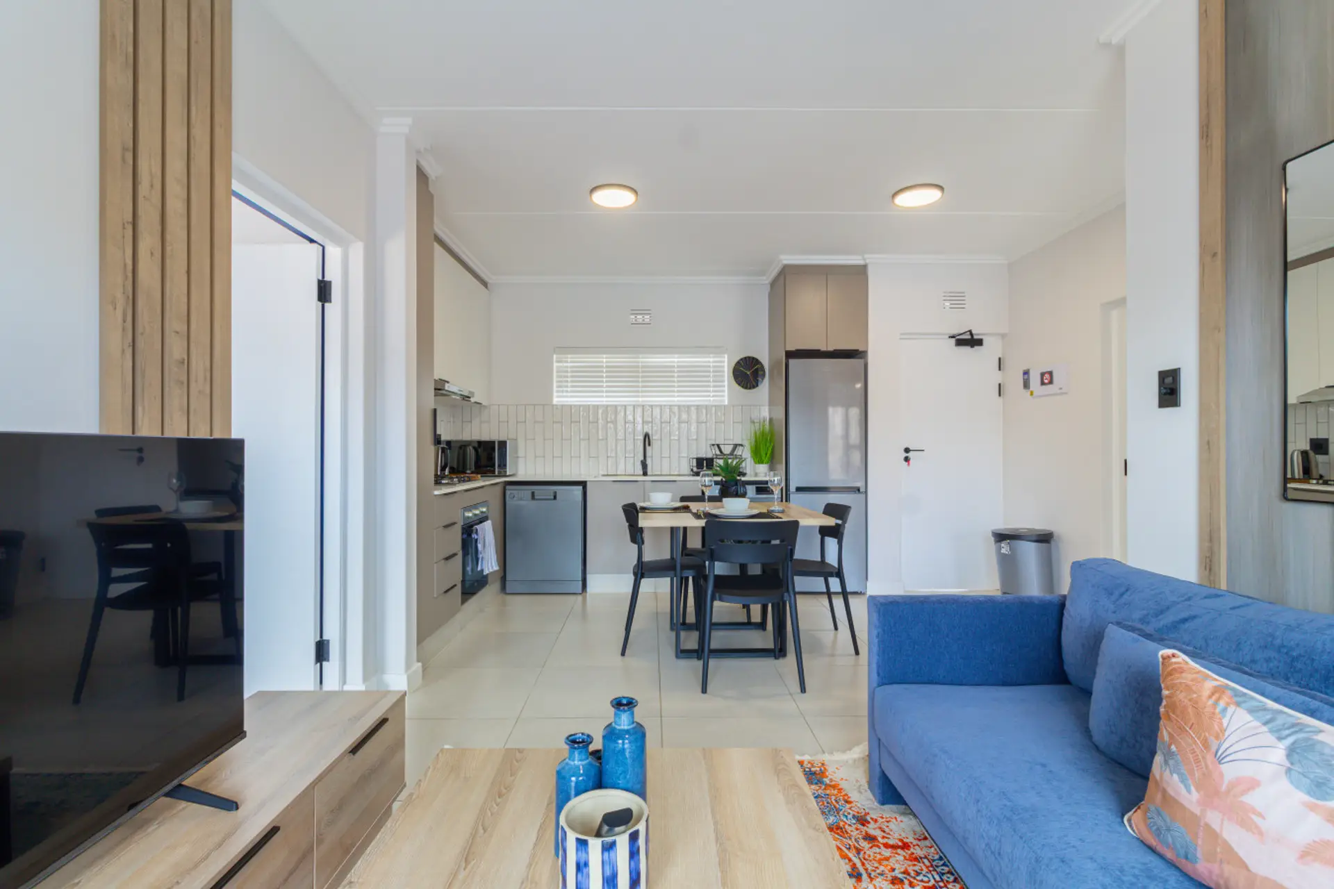 Open-plan living, dining and kitchen area leading out to the balcony