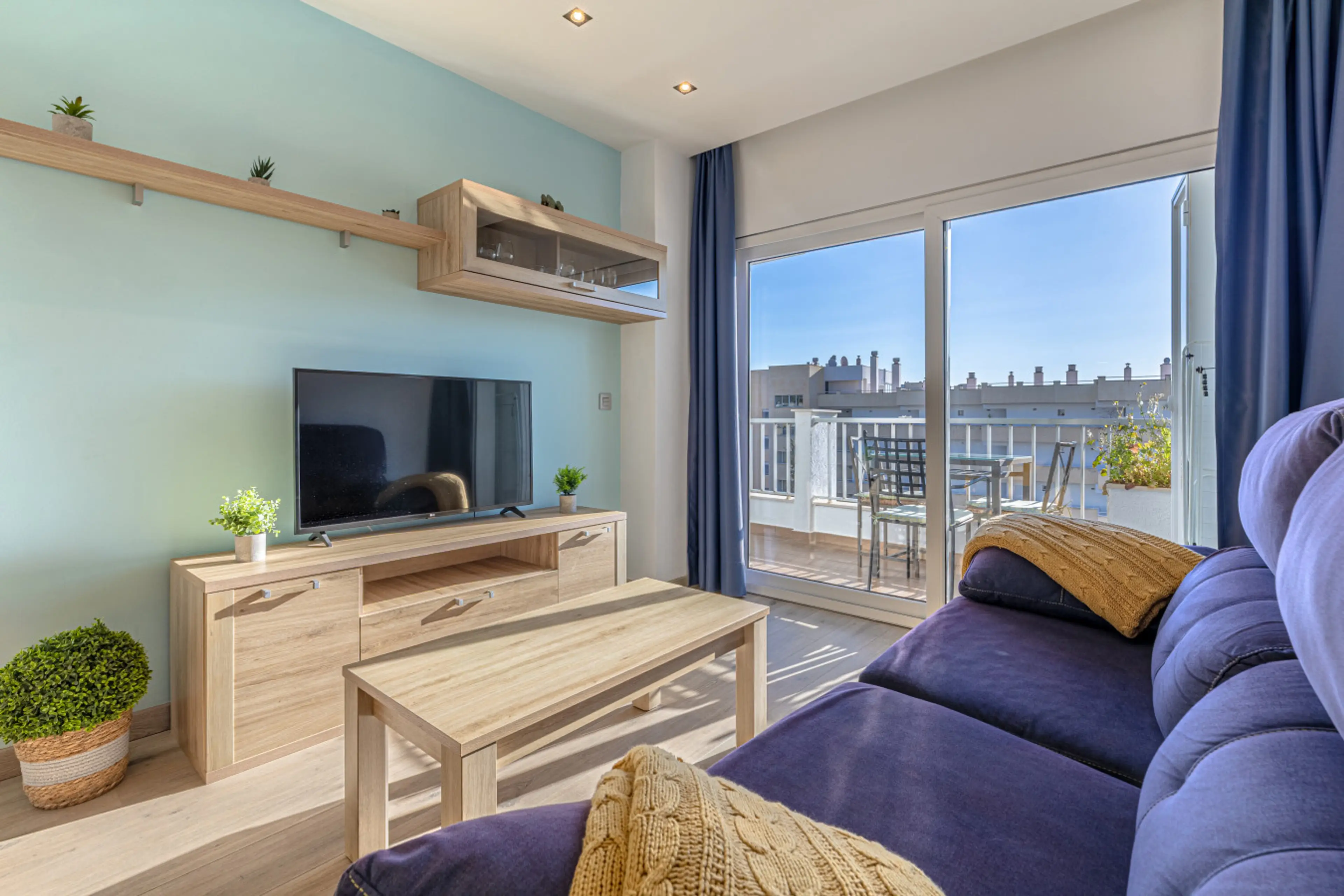 Relax in the bright and airy lounge of this Marbella beachside rental, offering natural Andalusian sunlight and sliding glass doors that open straight onto the private terrace.