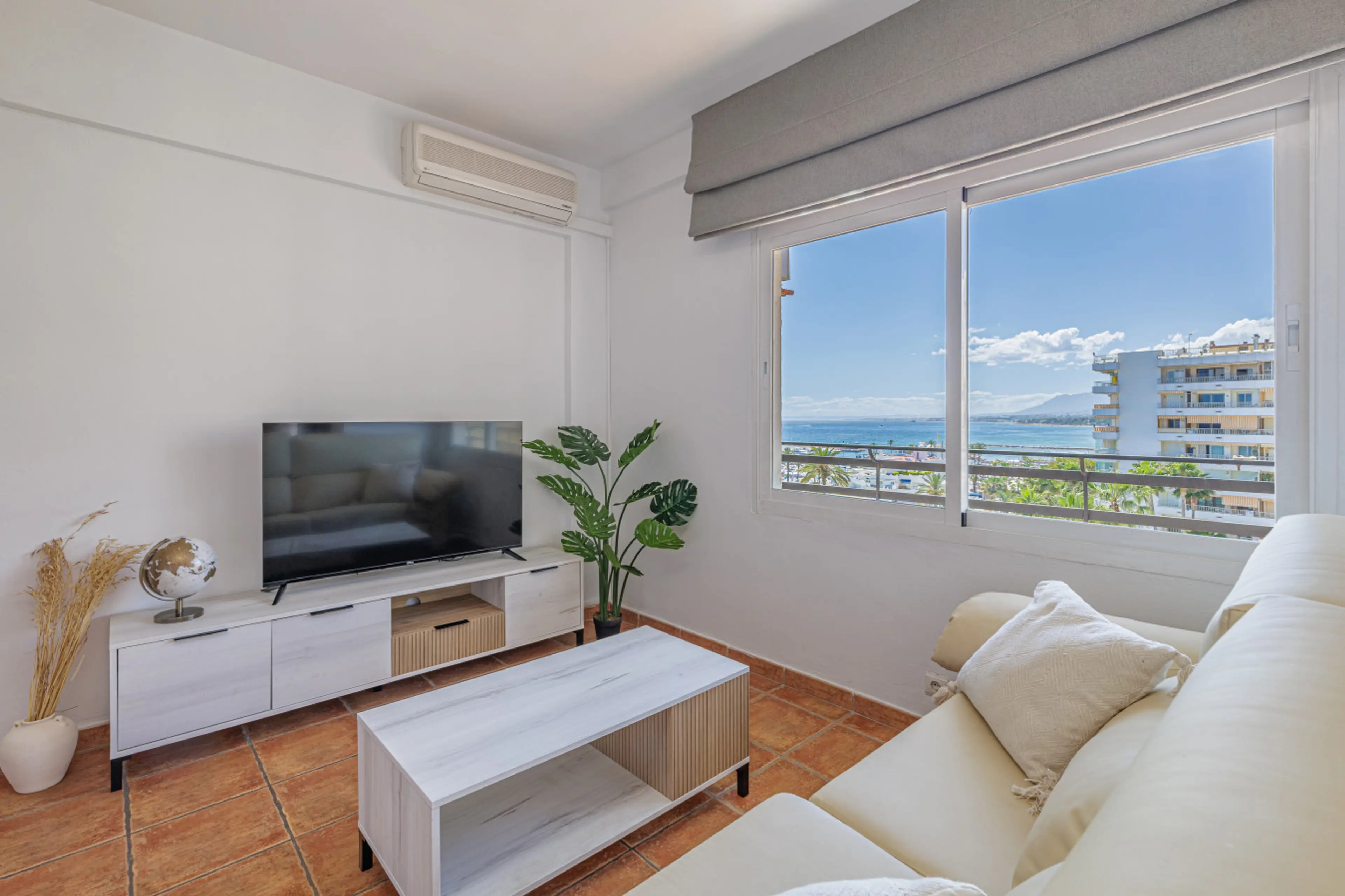 Relax in the air-conditioned living area while enjoying direct sea views and natural light.
