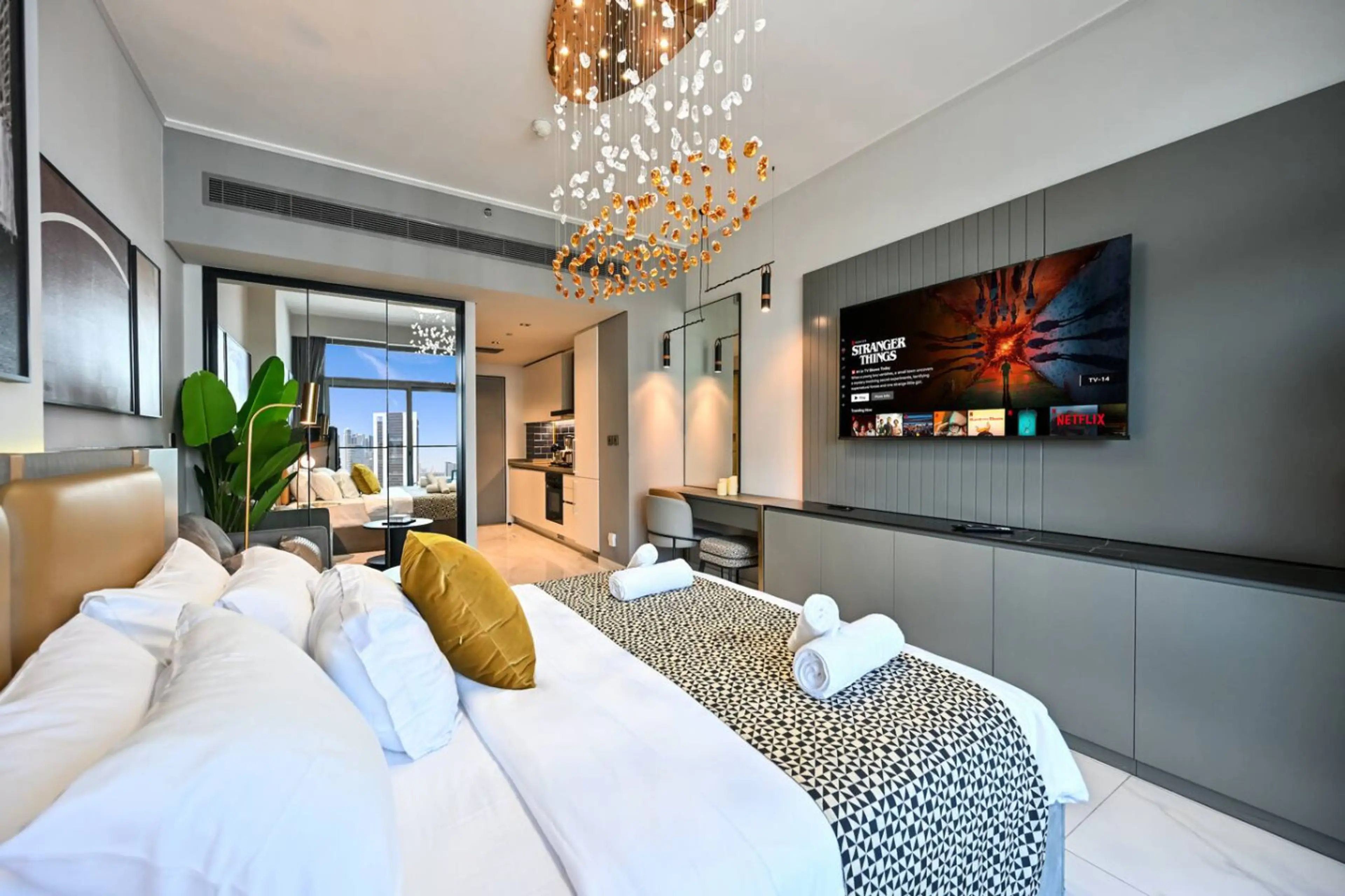 Step into elegance with this designer studio featuring sleek interiors, a statement chandelier, and a private balcony overlooking the city skyline. A perfect blend of luxury and comfort.
