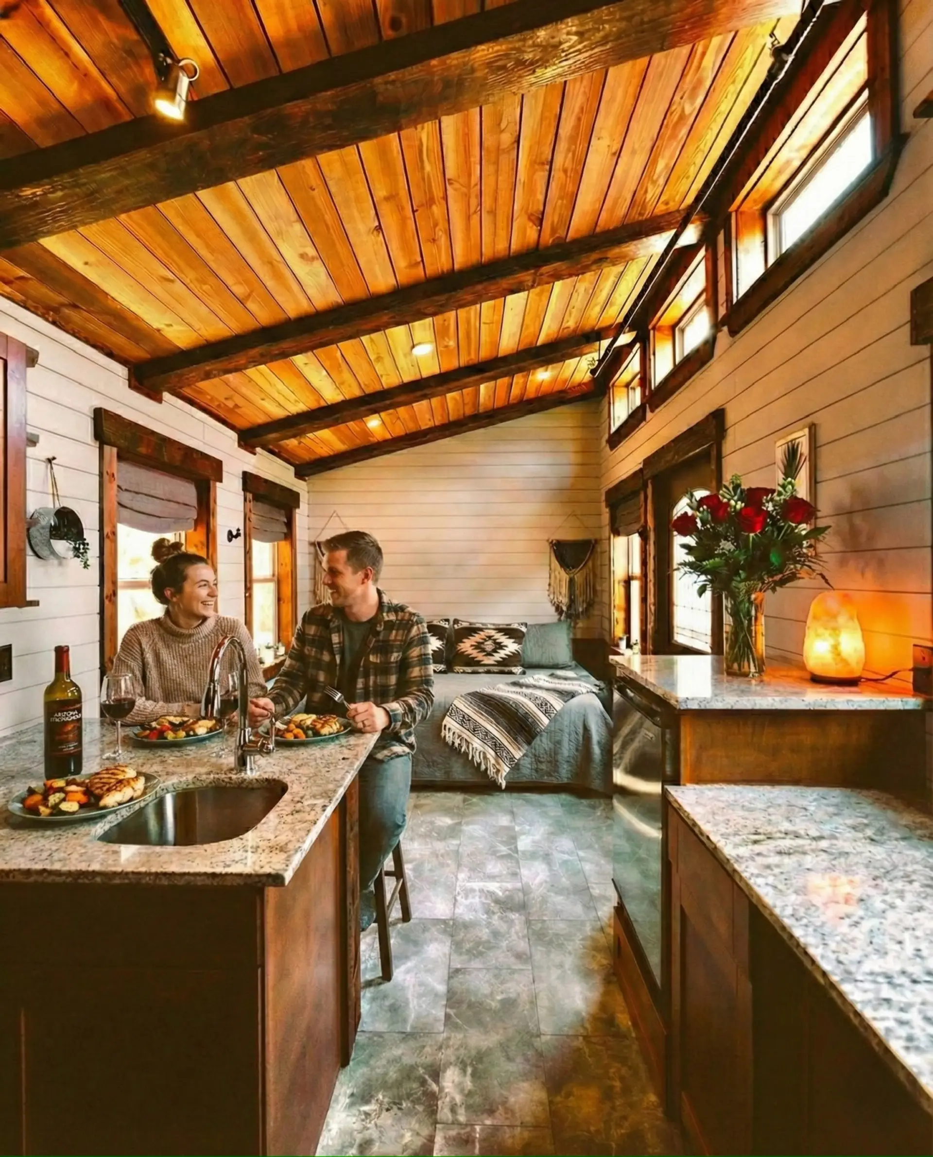 Relax inside a beautifully designed tiny home featuring soaring wood ceilings, a fully equipped kitchen, comfortable sleeping area, and everything you need for a memorable getaway.
