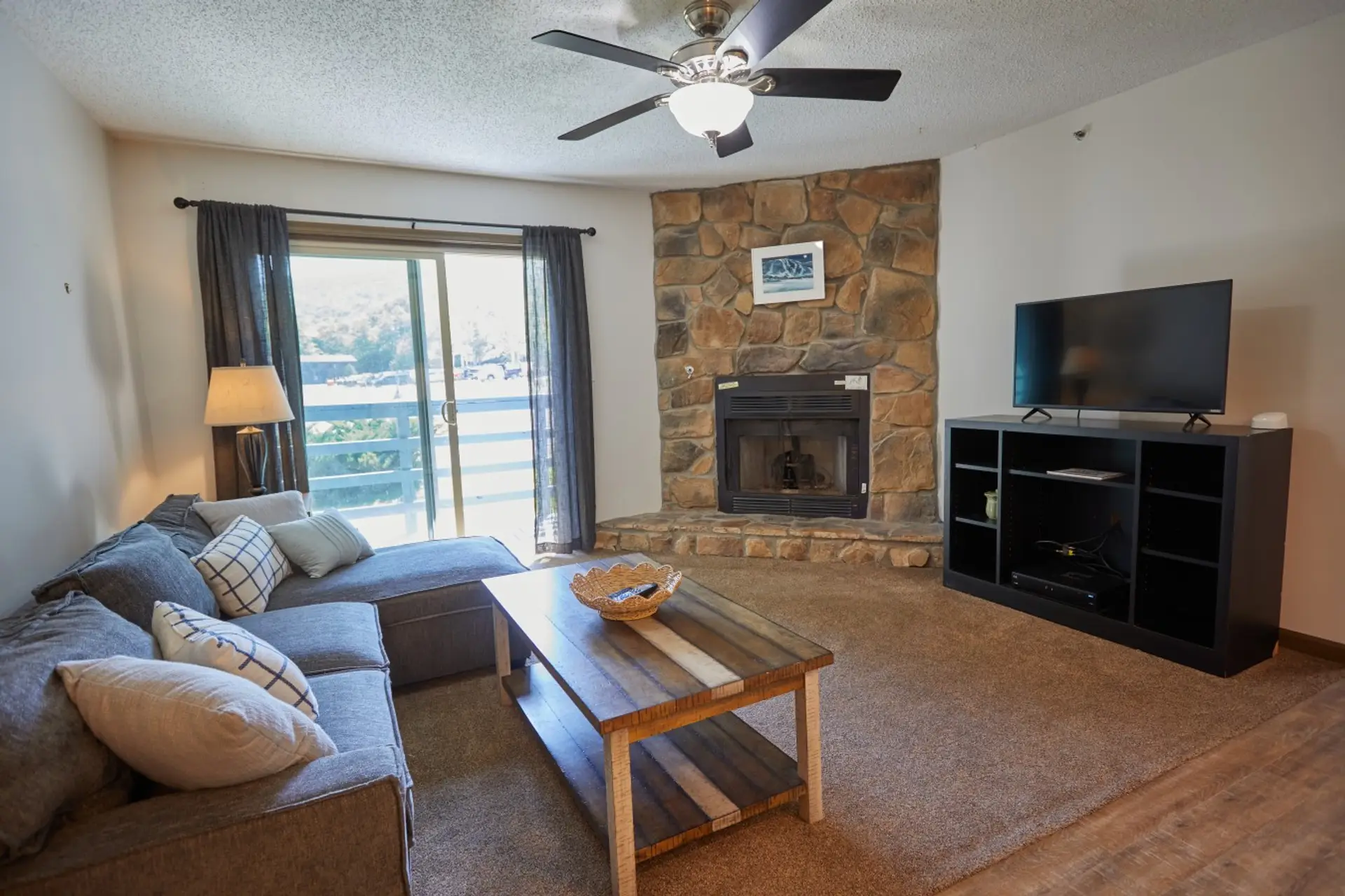 Large living room with fireplace and balcony