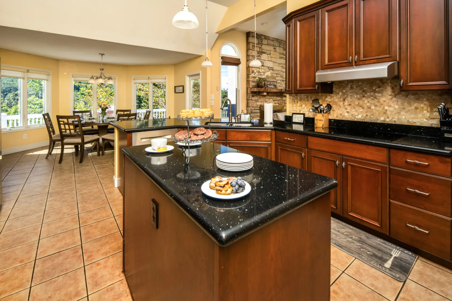 Kitchen & Dining | Open-concept with granite counters, center island, and a bright dining area overlooking mountain views