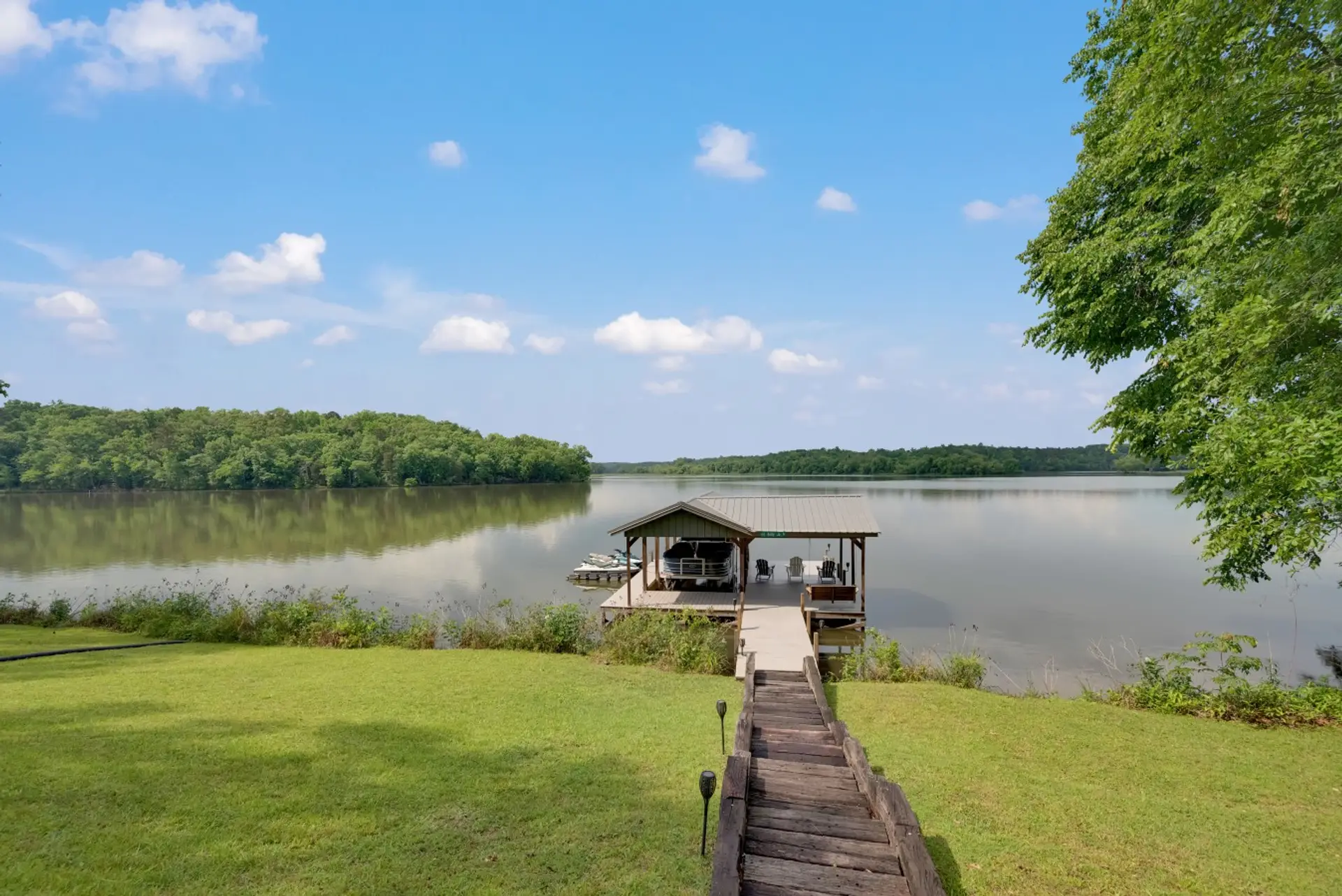 Dock | Covered Boat Slip | Lake Views & Seating Area