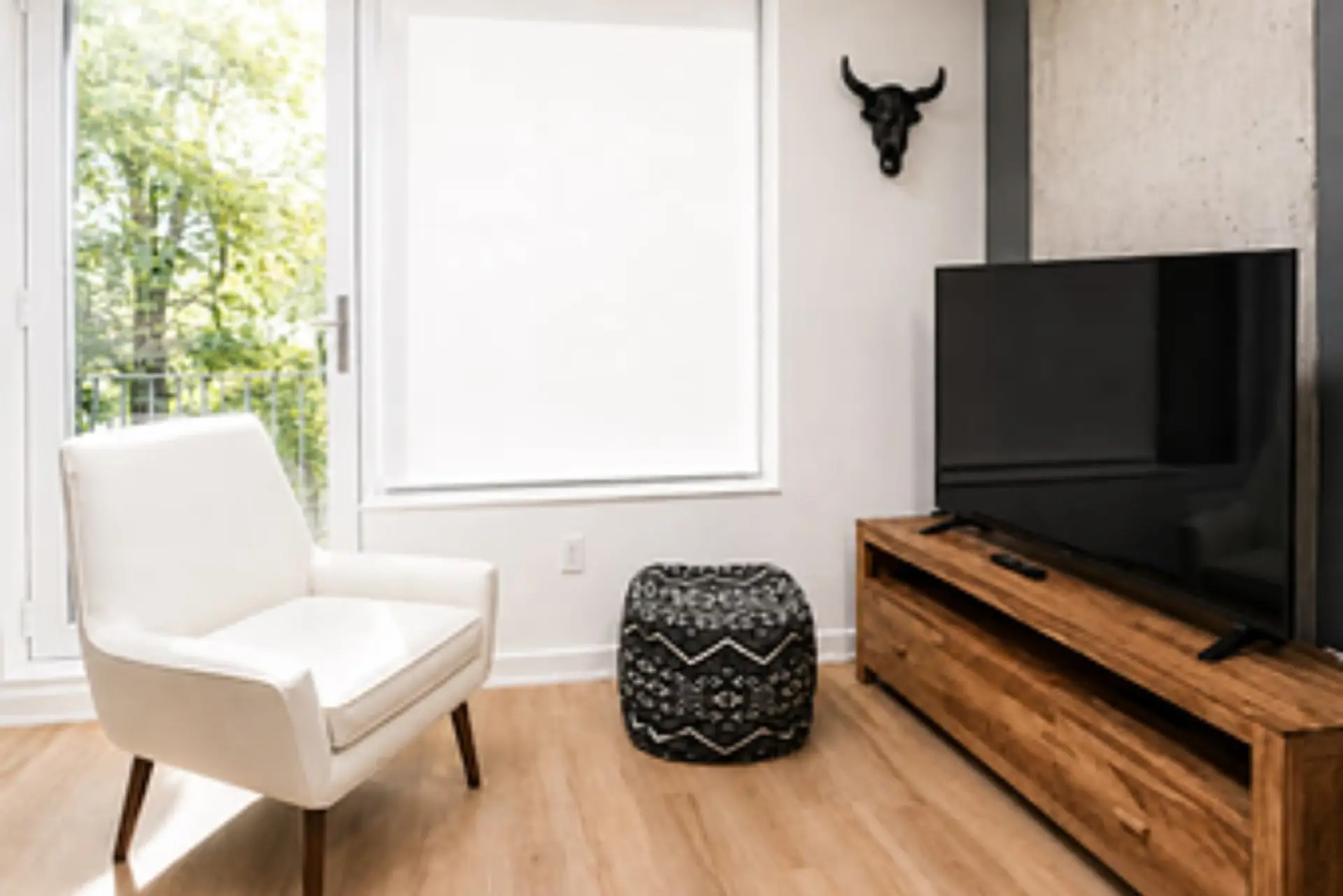 Kick back after a day of exploring in this cozy, light-filled living room with a Smart TV and private balcony access.