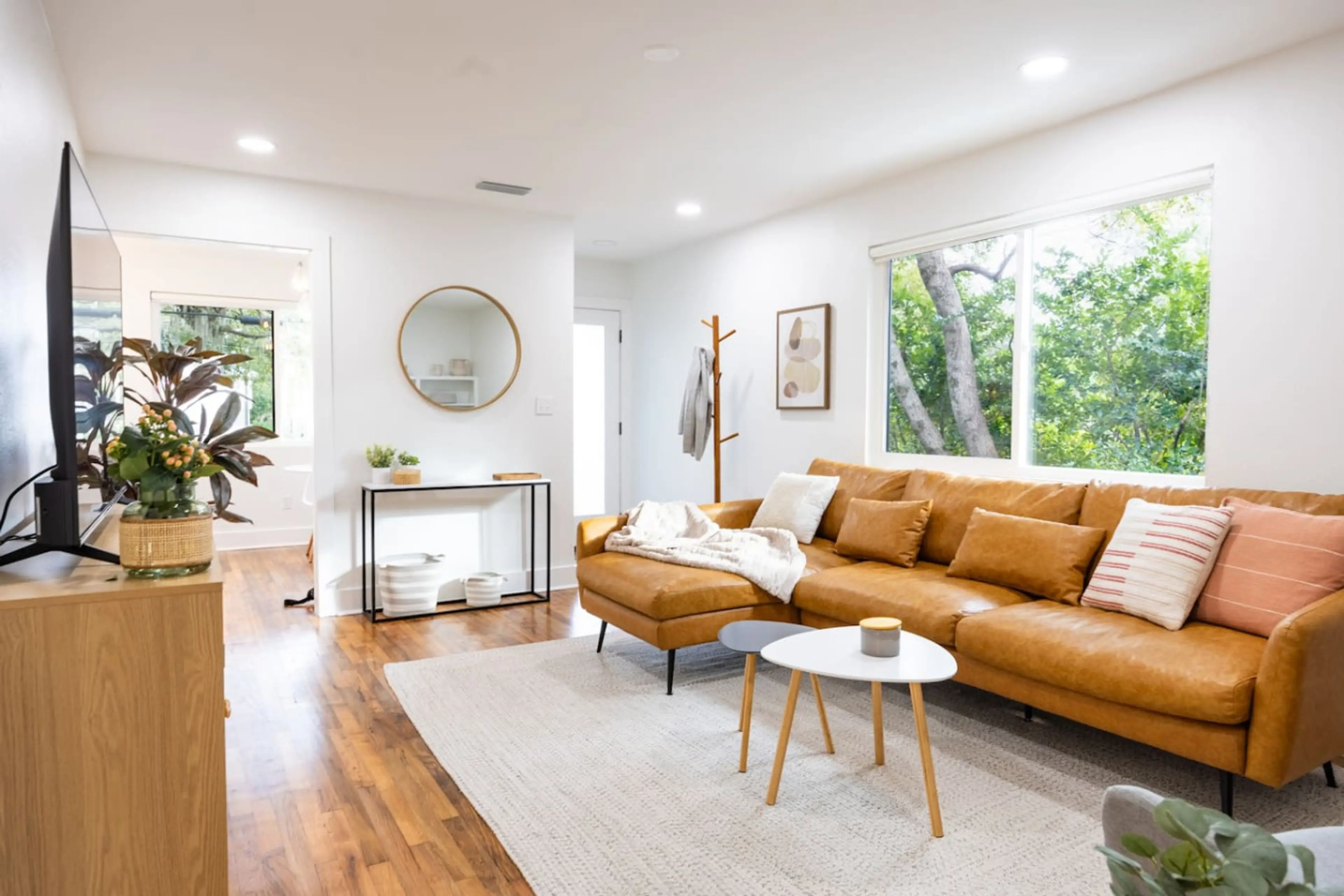 Bright and inviting living space with stylish décor, a cozy sectional, and plenty of natural light.