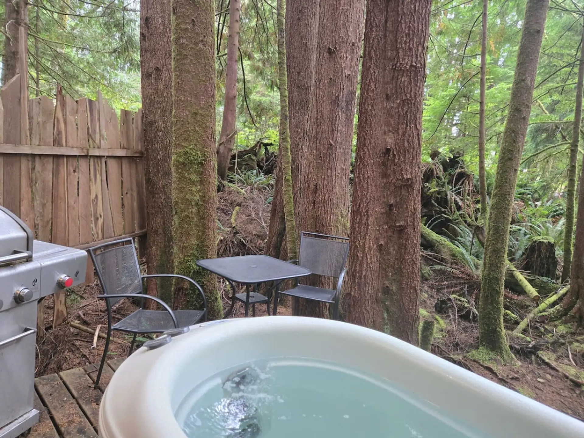 deck with private 2 person hot tub, barbeque, and outside seating