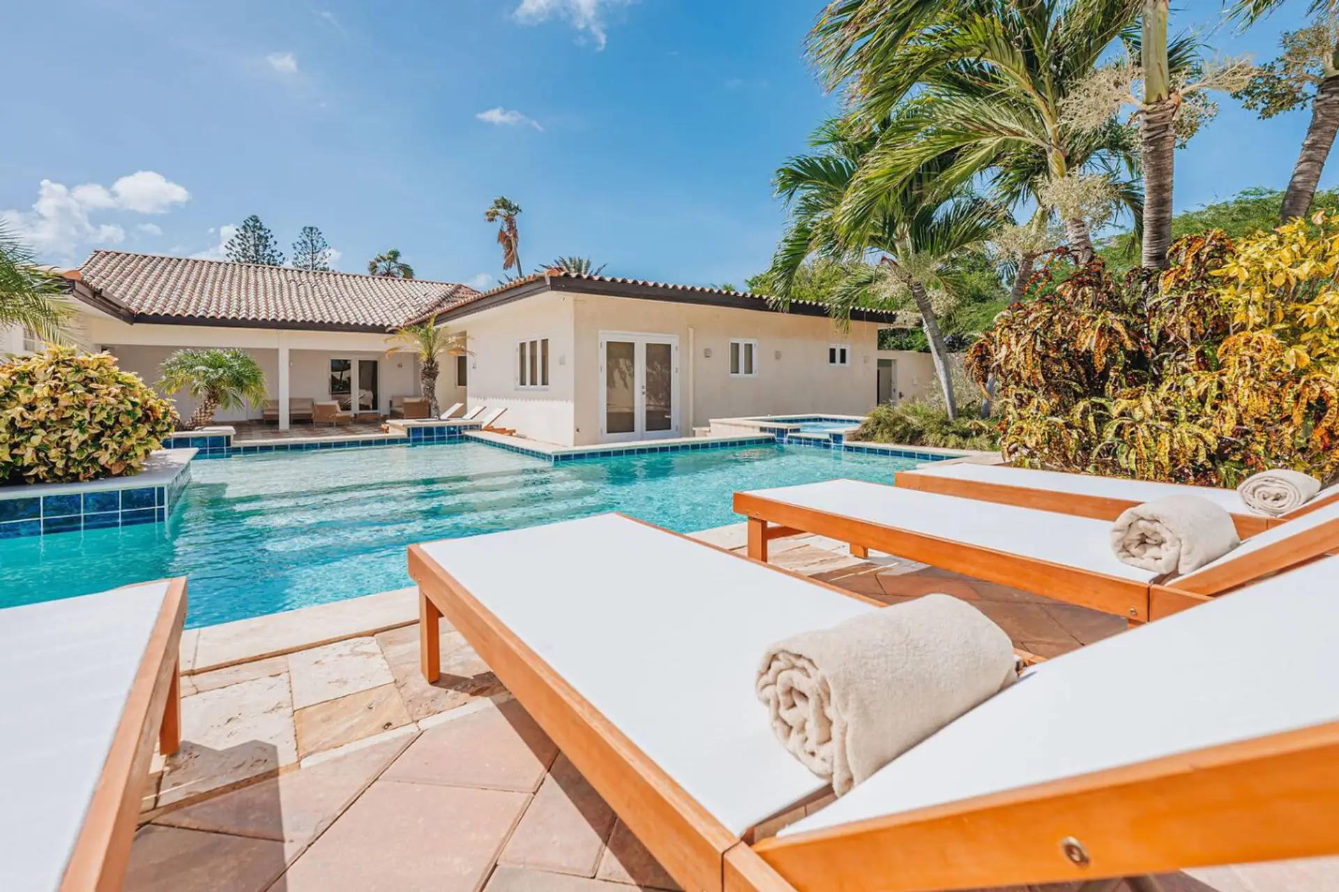 Experience your private sun-soaked sanctuary. The spacious deck and sparkling pool offer luxurious, tranquil relaxation for all.