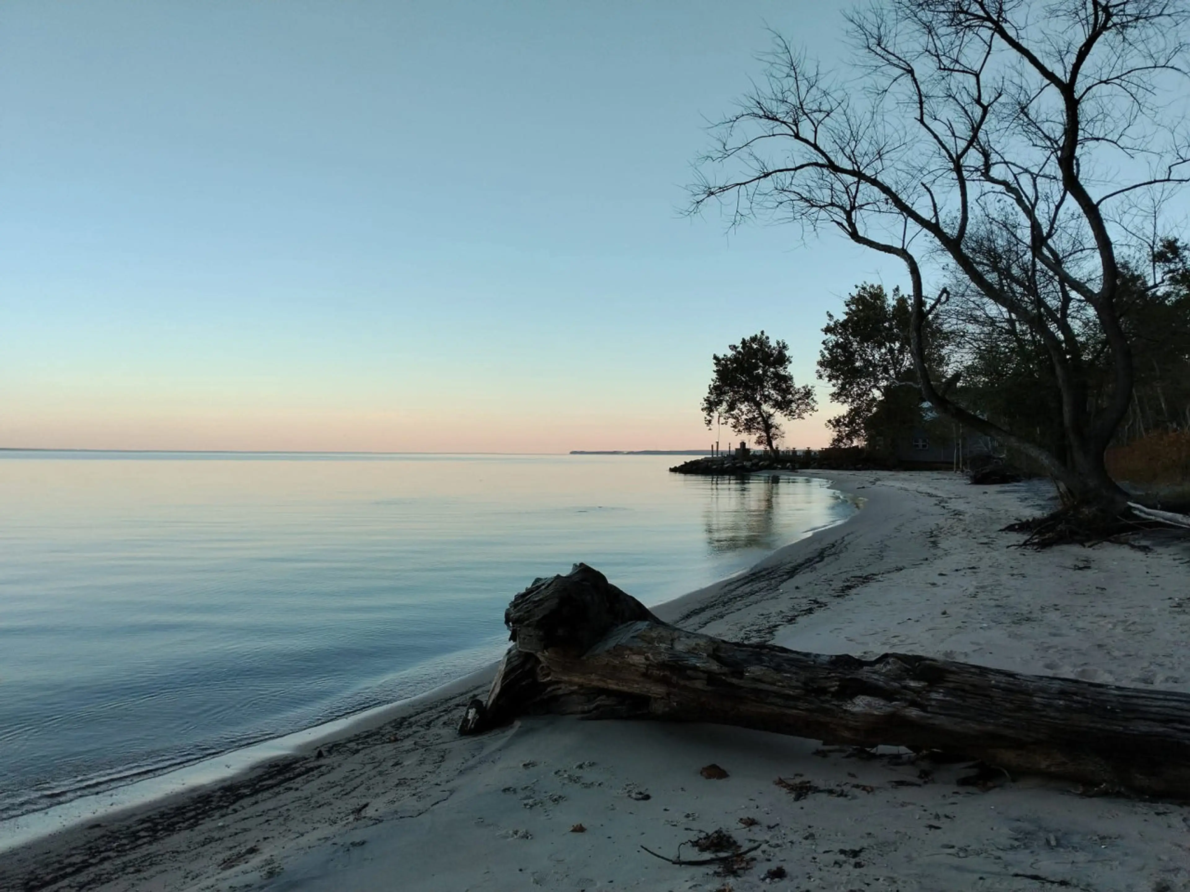 Beachfront area with water views and sunset