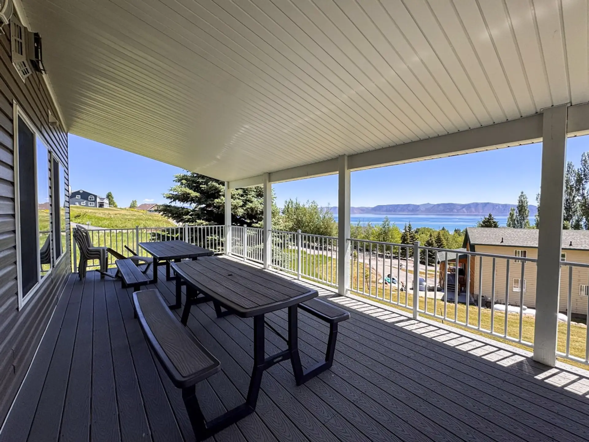 Relax on the covered deck with stunning lake views and crisp mountain air all around