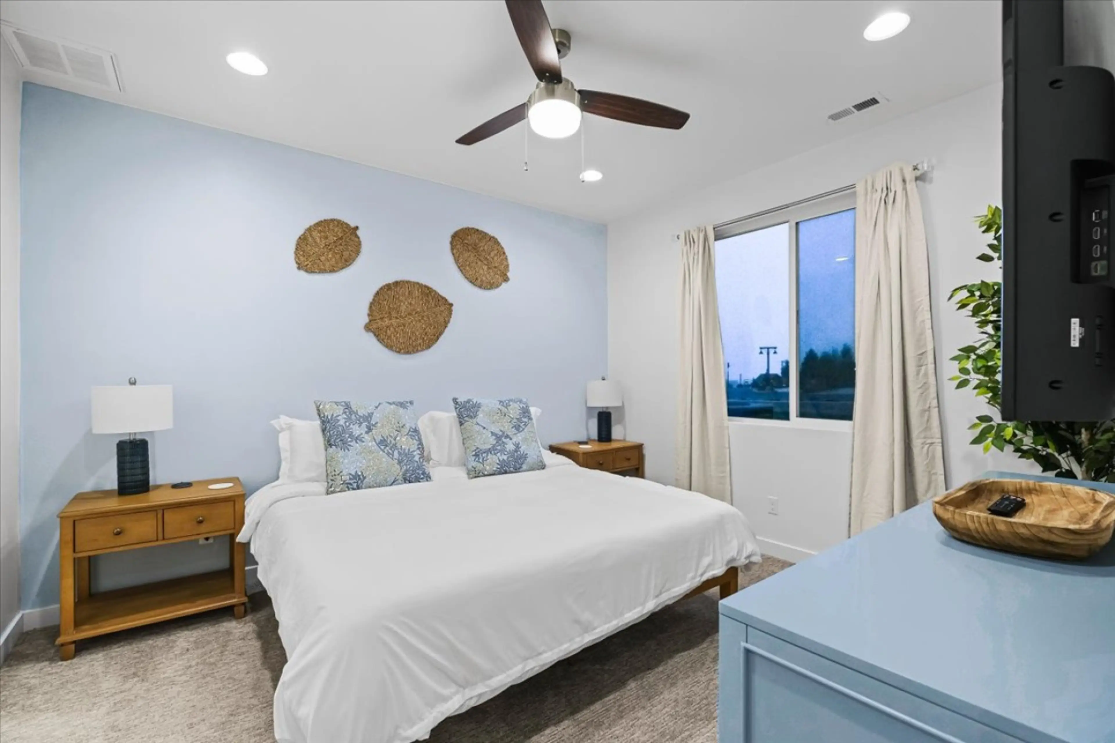 Serene bedroom retreat with soft blue accents, cozy textures, and calming natural light