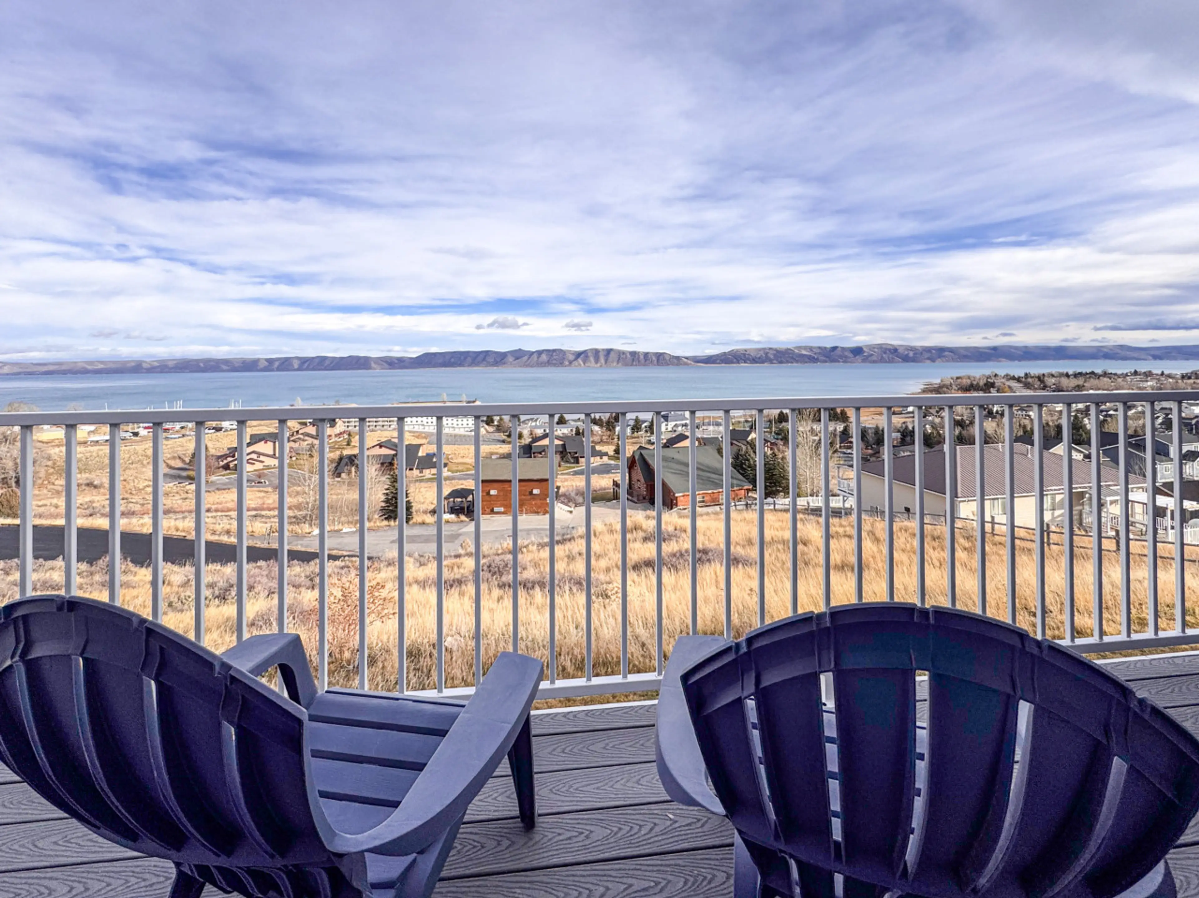 Relax on the balcony with stunning lake views, open skies, and peaceful mountain scenery.