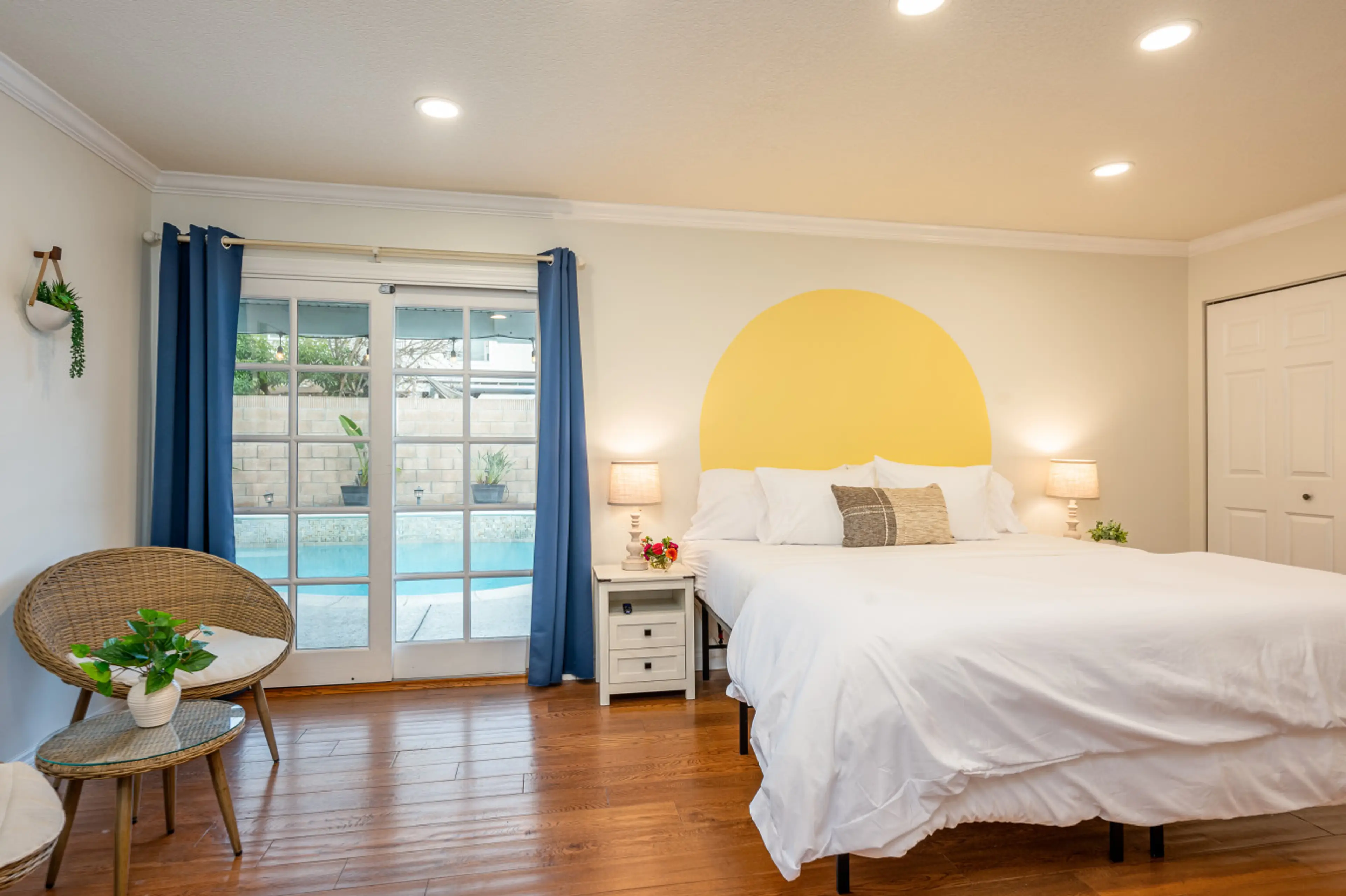 The downstairs master suite features a beautiful view of the pool