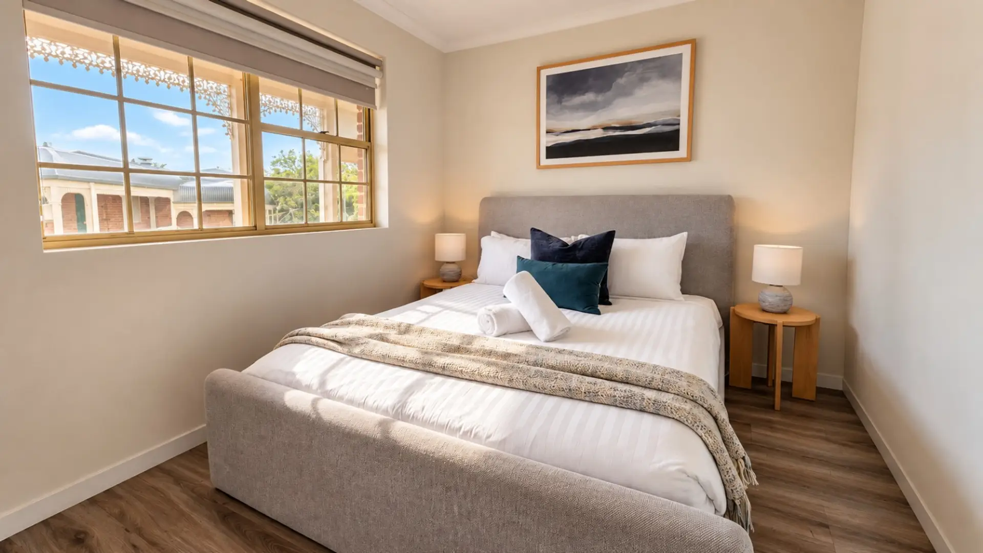 Enjoy a restful stay in this light-filled bedroom, complete with crisp bedding, inviting cushions and soft touches throughout. The generous windows bring in plenty of natural light, creating a calm and welcoming atmosphere.