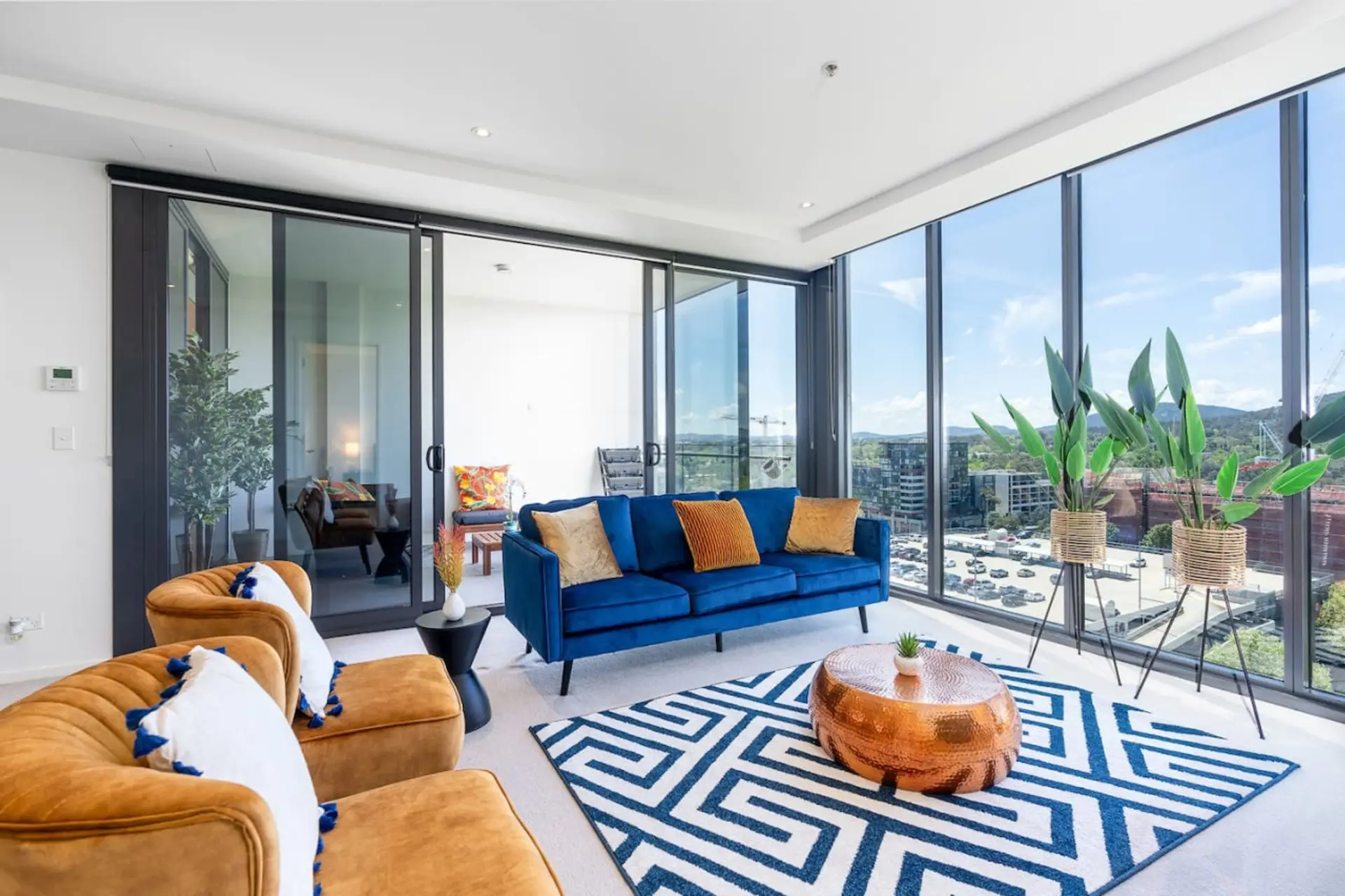 A cosy living room perfect for entertaining friends and family. Feel at ease with our clean and  comfy sofa, soft throws and a combination of happy colors.