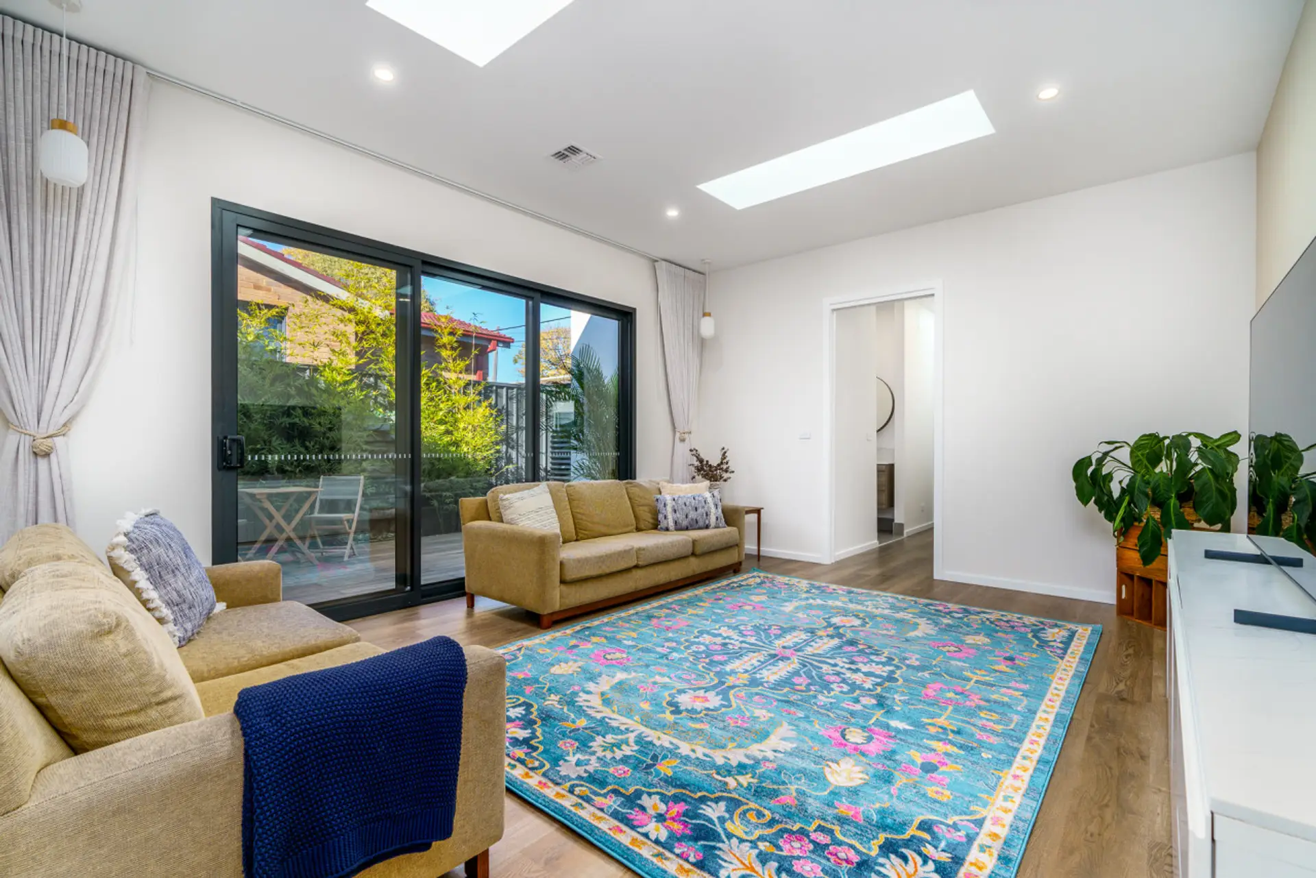 Bright and airy Formal Living rooms featuring cozy seating, vibrant decor, and large sliding doors that lead to an outdoor area. Perfect for relaxation and enjoying the natural light.