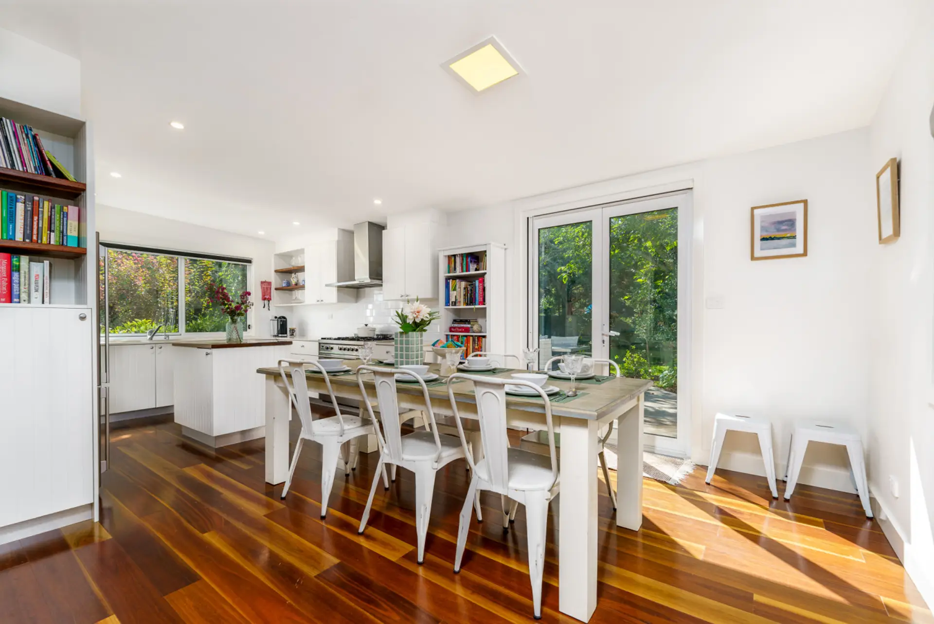 Spacious 6-seater dining table surrounded by large windows, offering picturesque views and abundant natural light for a delightful dining experience.