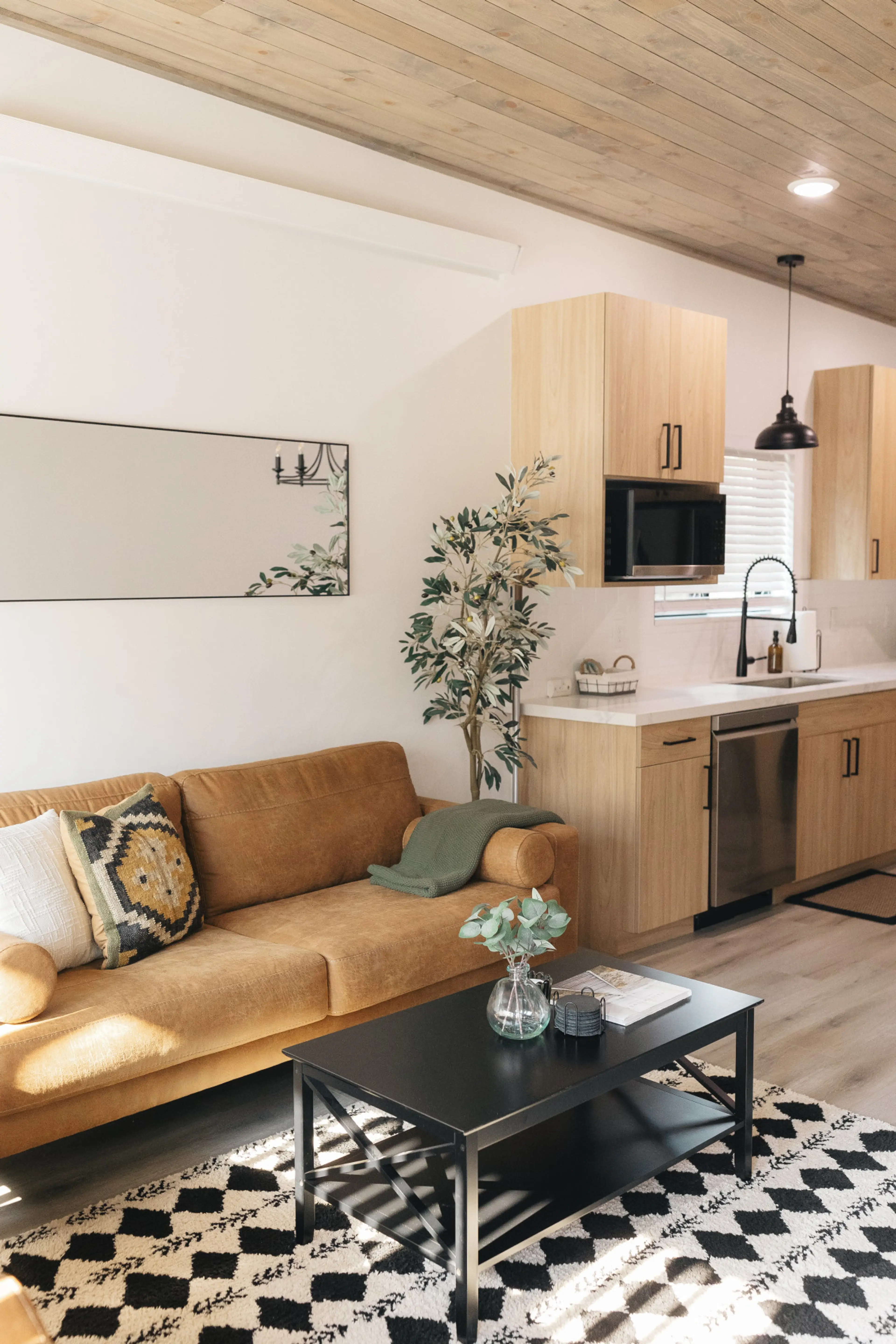 Living room with two large couches next to the kitchen.