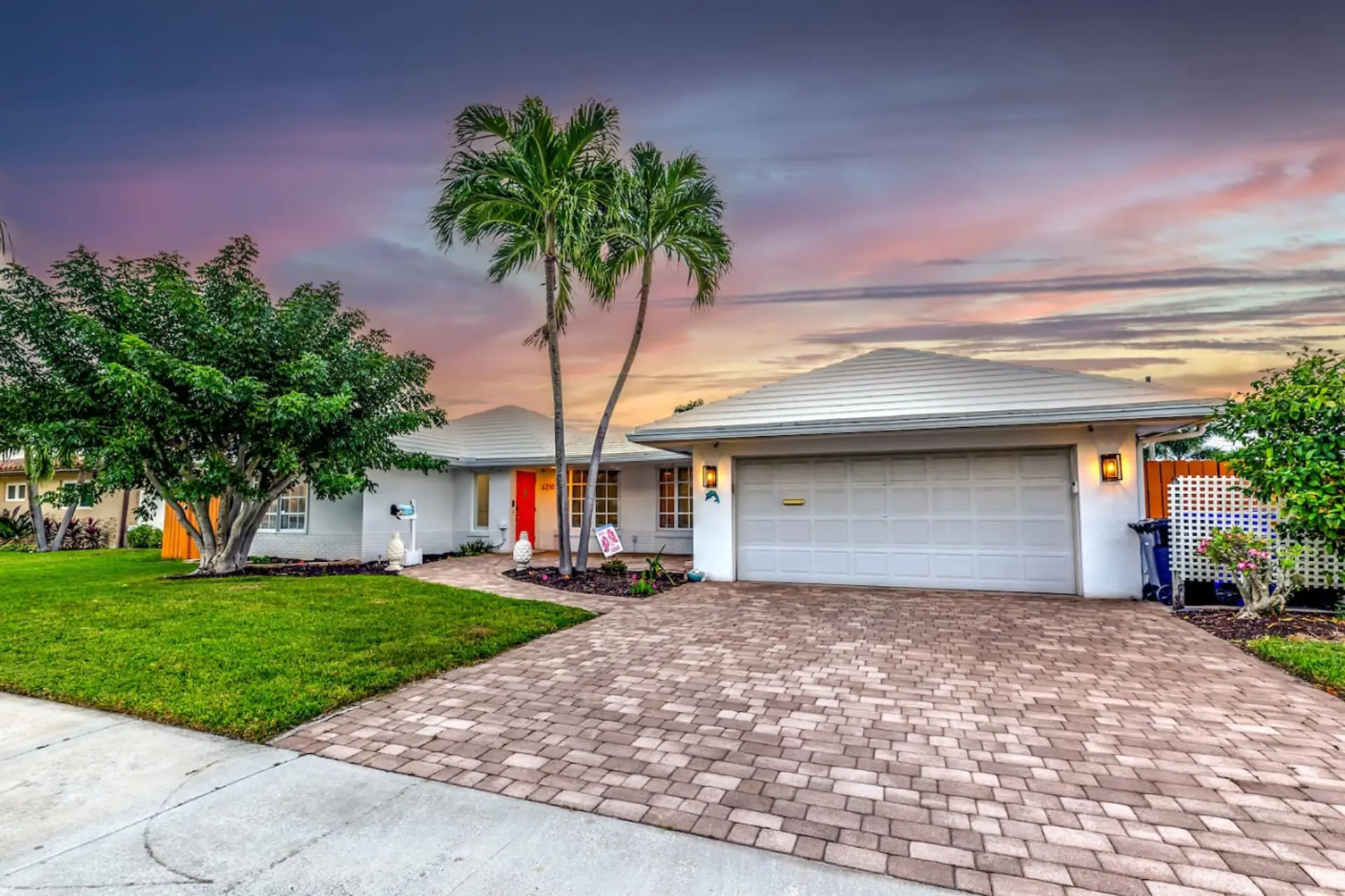A perfect tropical getaway home with a driveway large enough to accommodate two cars.