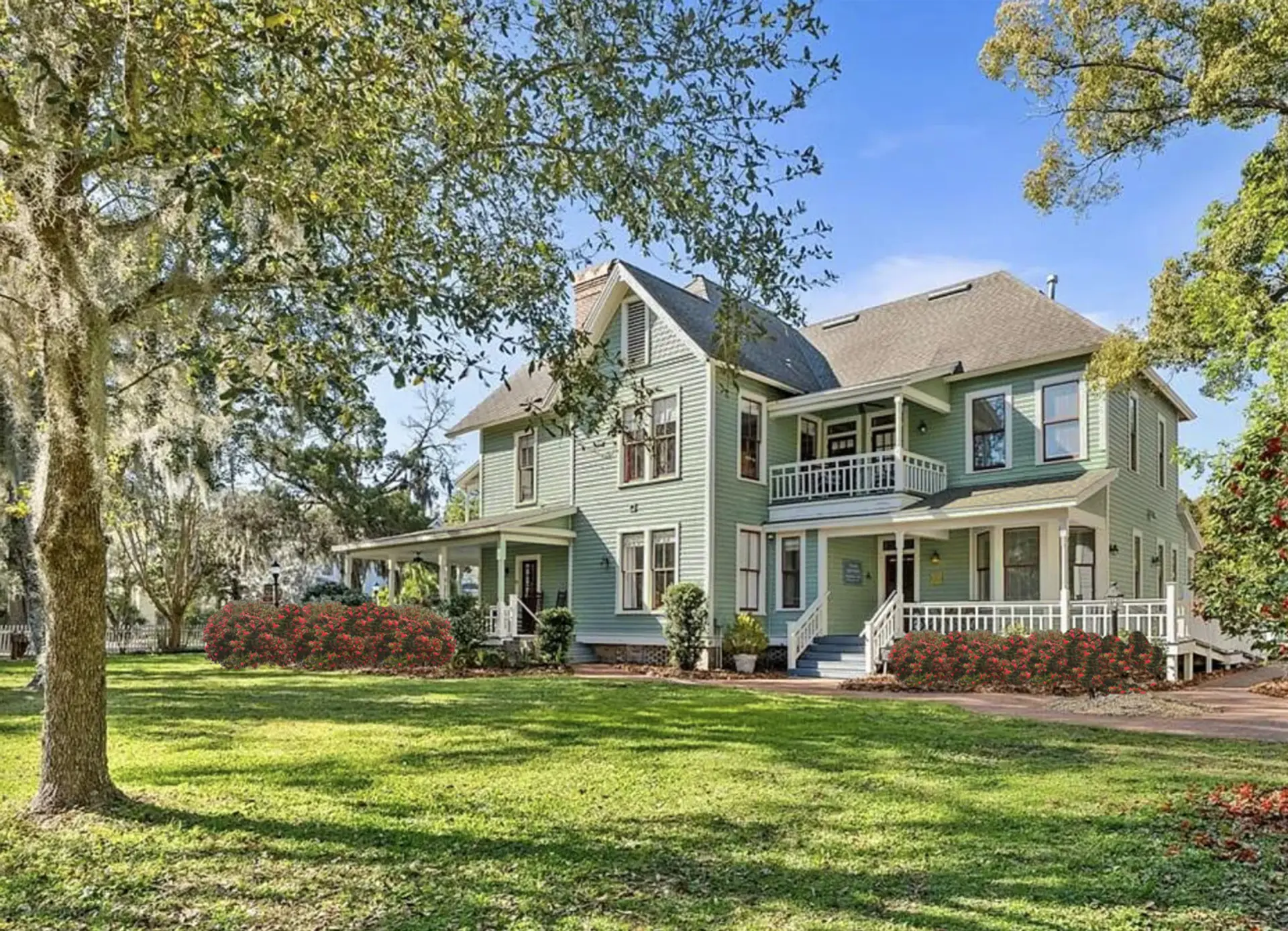 The spacious and lush backyard, a view of the upper porch, lower back porch and side porch