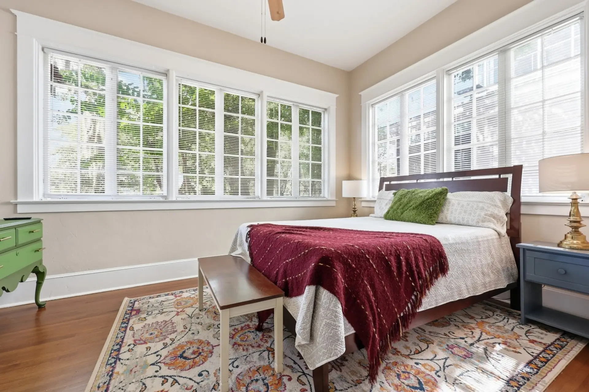 Bedroom: Bright, spacious bedroom surrounded by windows and abundant natural light.
