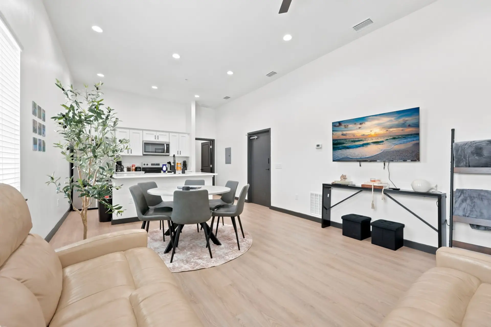 Living & Dining Area: Bright, open-concept living space with soaring ceilings, comfortable seating, dining for six, and a beautifully renovated kitchen.