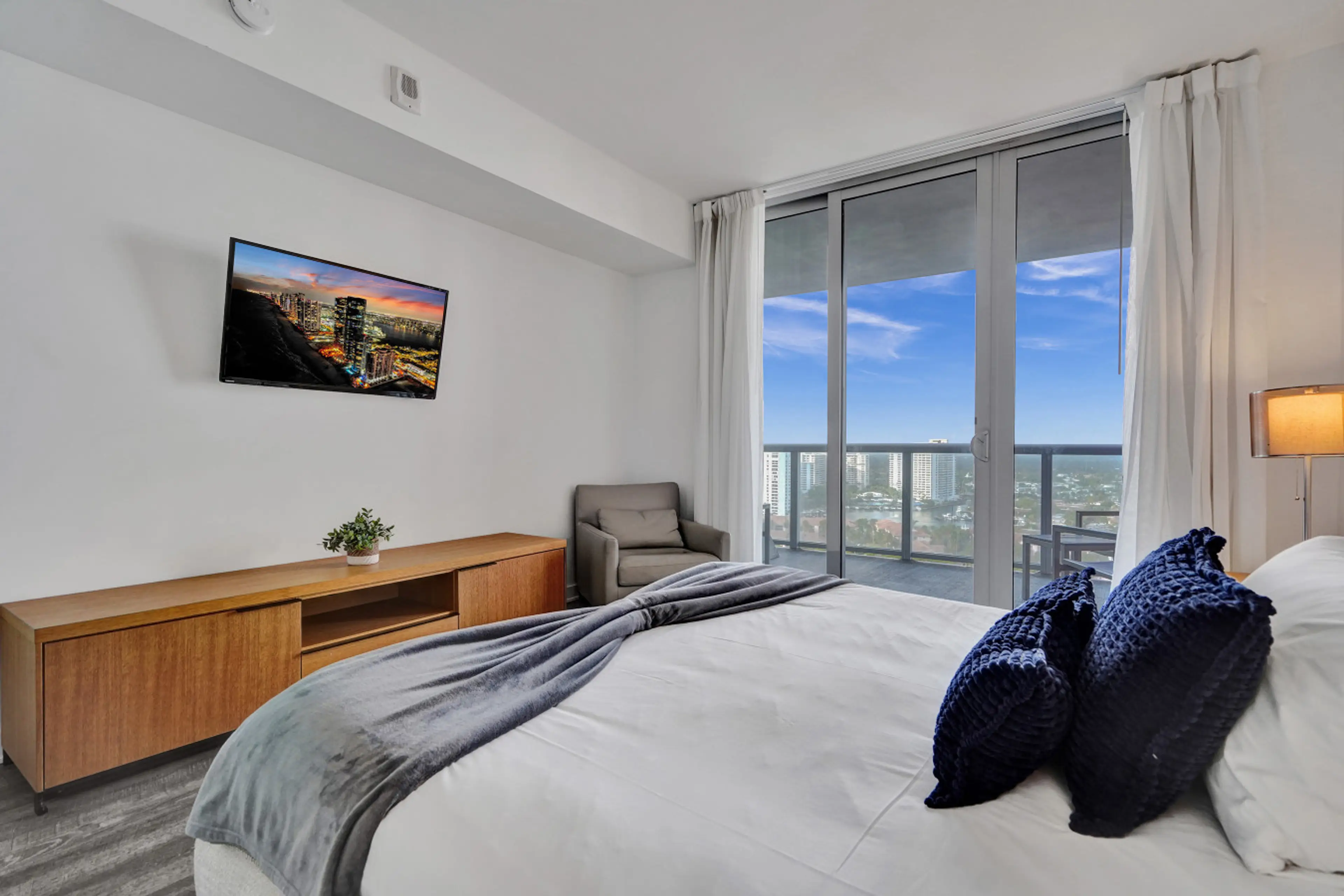Spacious bedroom with king size bed and city view