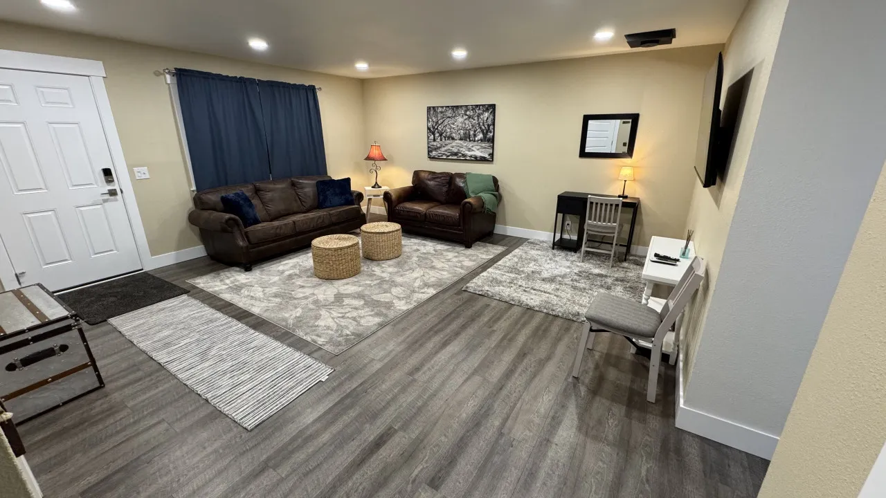 Comfortable living room with leather sofas and a workspace