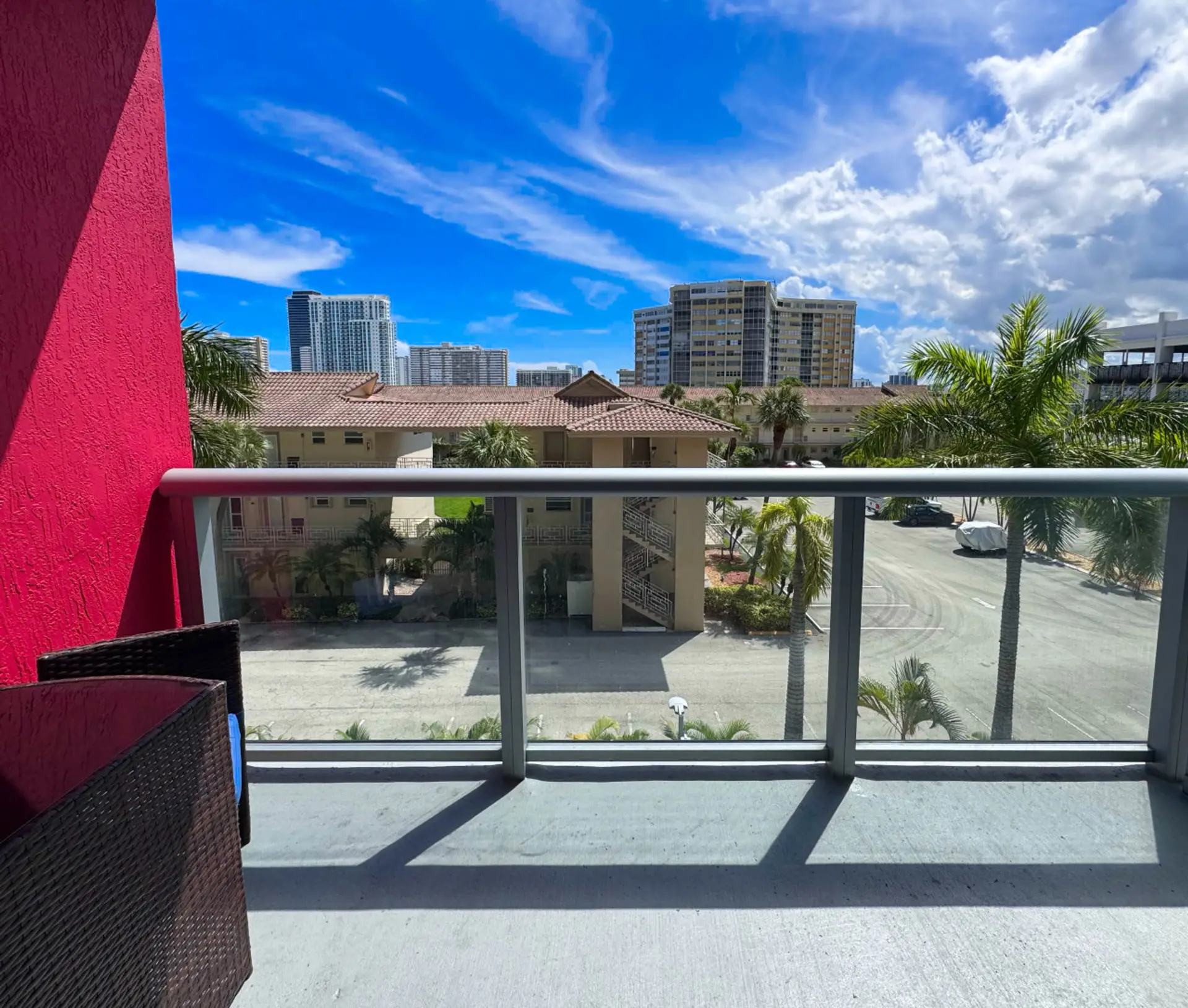 Private balcony with chairs and open city views.
