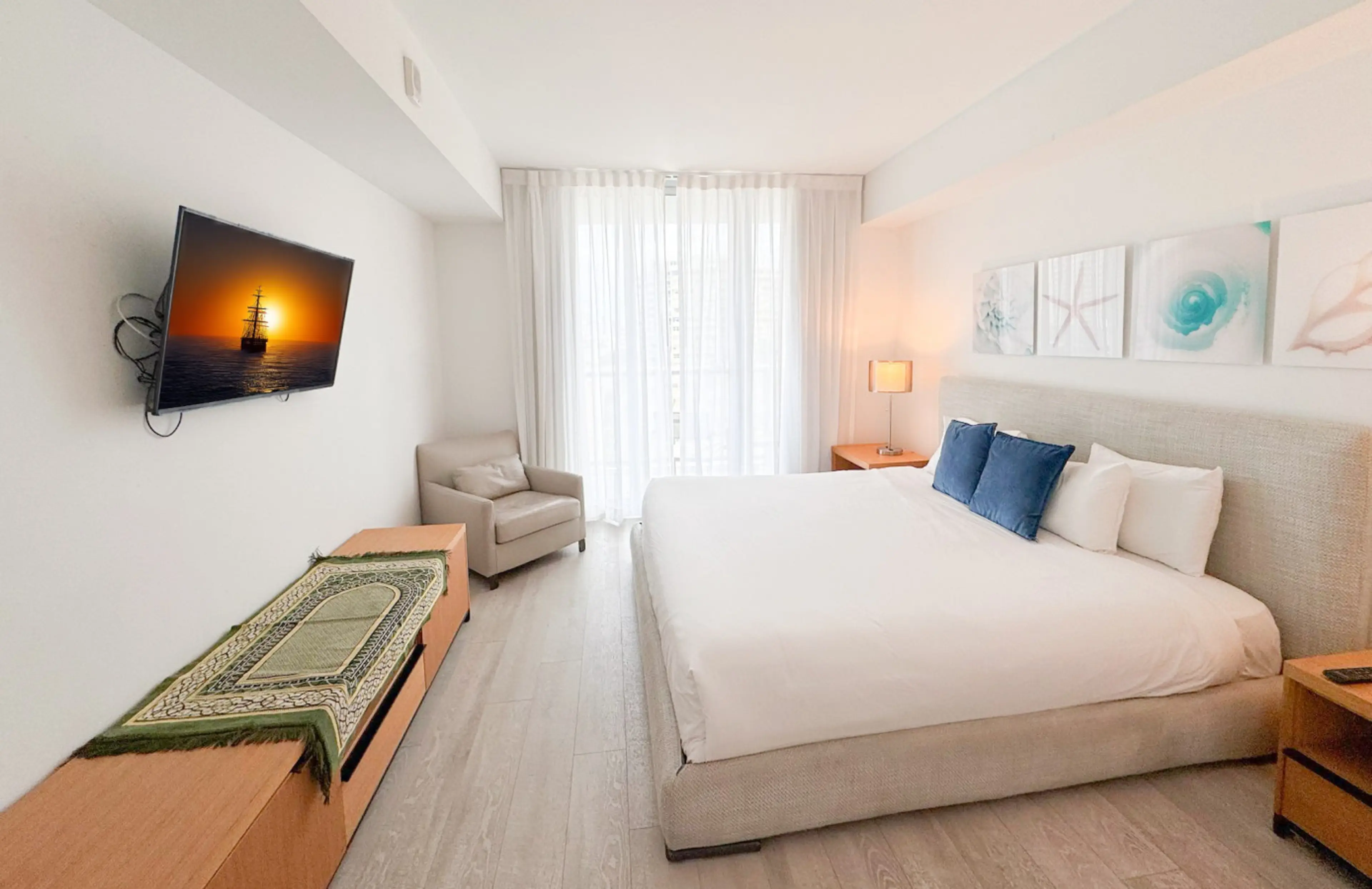 Spacious bedroom with large bed and plenty of natural light.