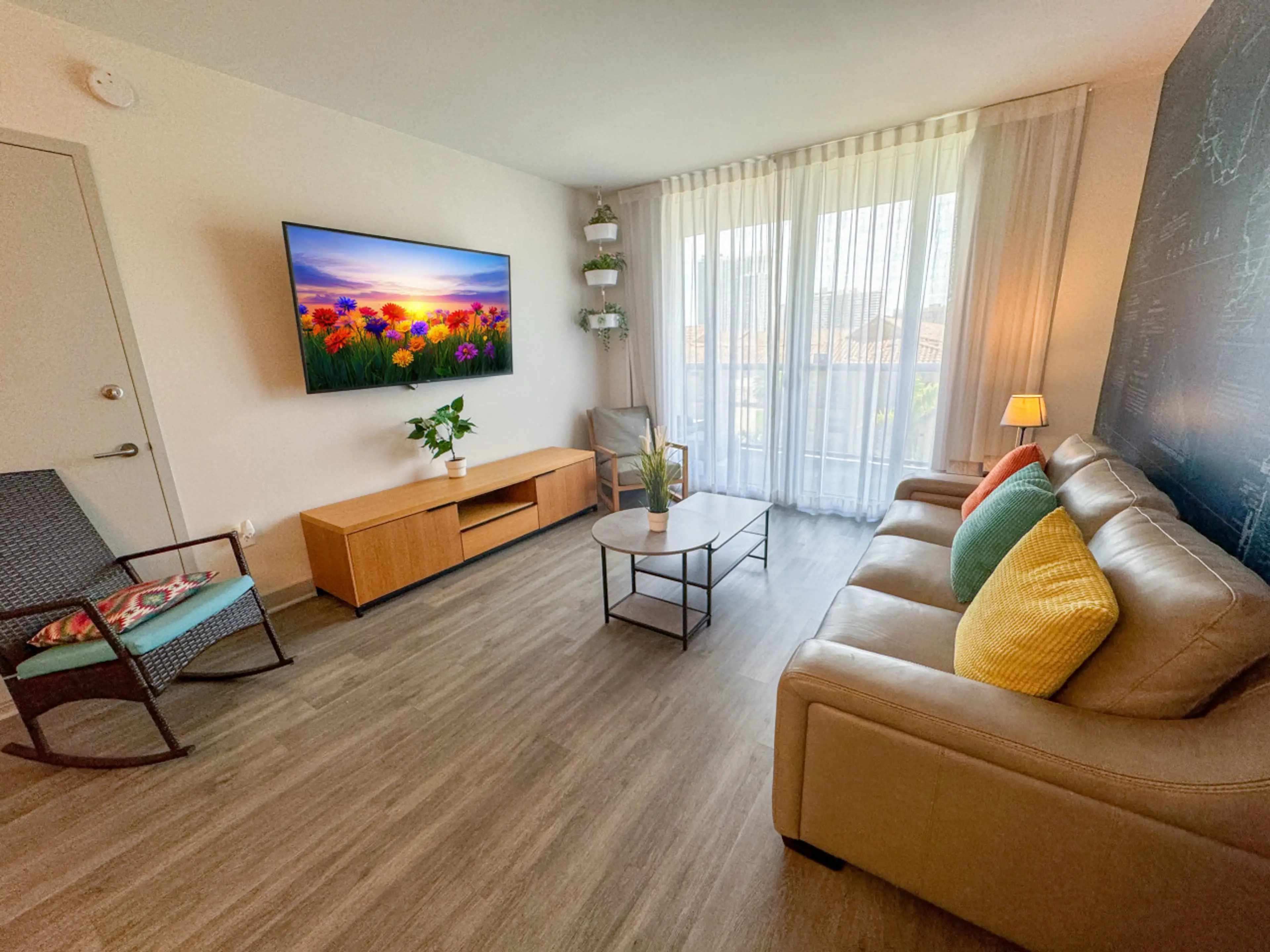 Relax in this stylish living room with smart TV and natural light.