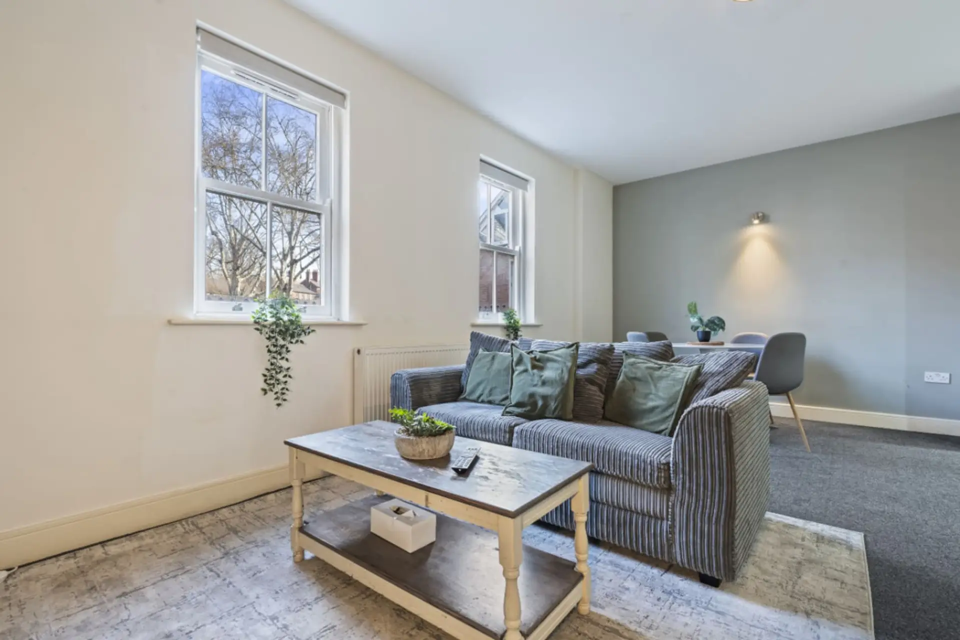 A bright and welcoming living room with a dining area conveniently positioned alongside it, perfect for relaxing, socialising, and enjoying meals together. (Rich Property Management)