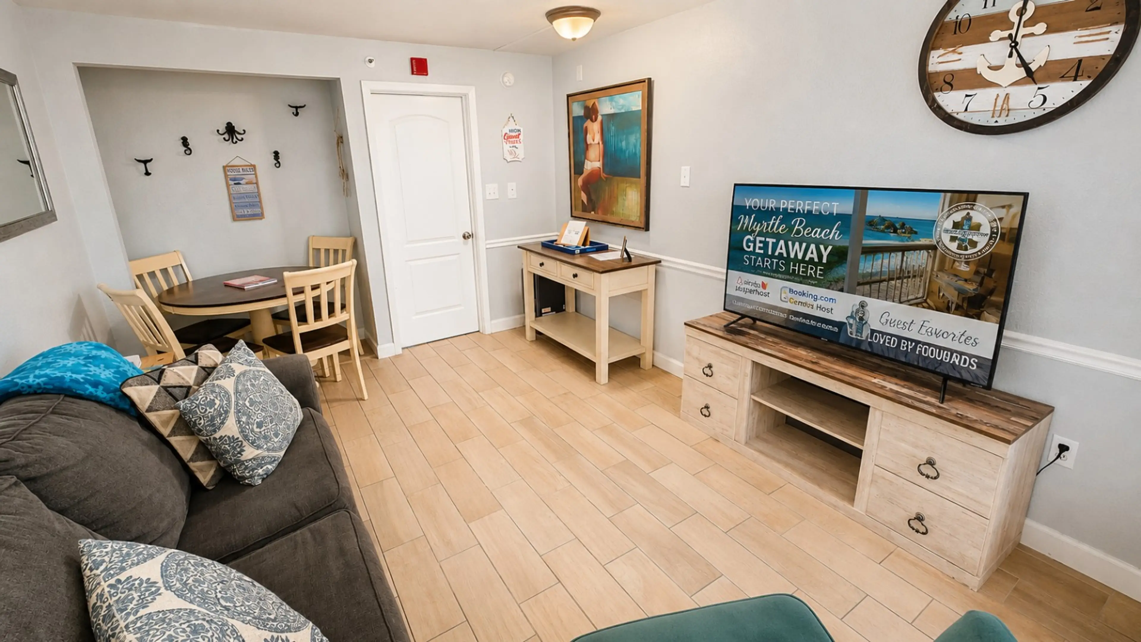 Relax in this bright and inviting coastal condo featuring stylish beach-inspired décor, a comfortable living area, and a spacious dining table perfect for meals, games, or planning your beach days. Just steps from the ocean, this cozy retreat offers the p