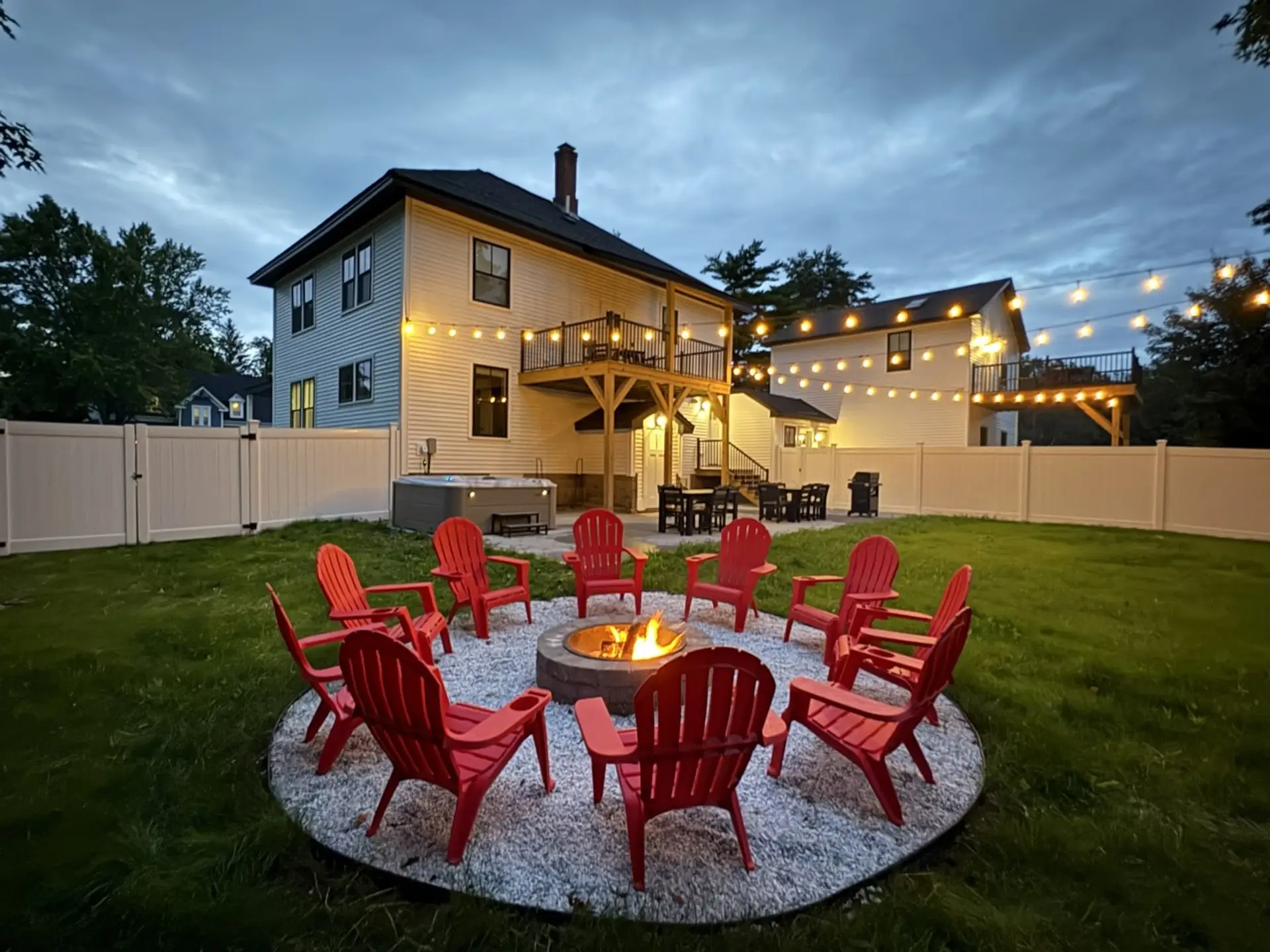 Big House: Backyard complete with a 7 person hot tub, firepit, large patio with a weber grill & two large outdoor tables, yard games, and bistro lights that light up a huge over 1/2 acre flat fenced in yard for the kids and dogs to run around!