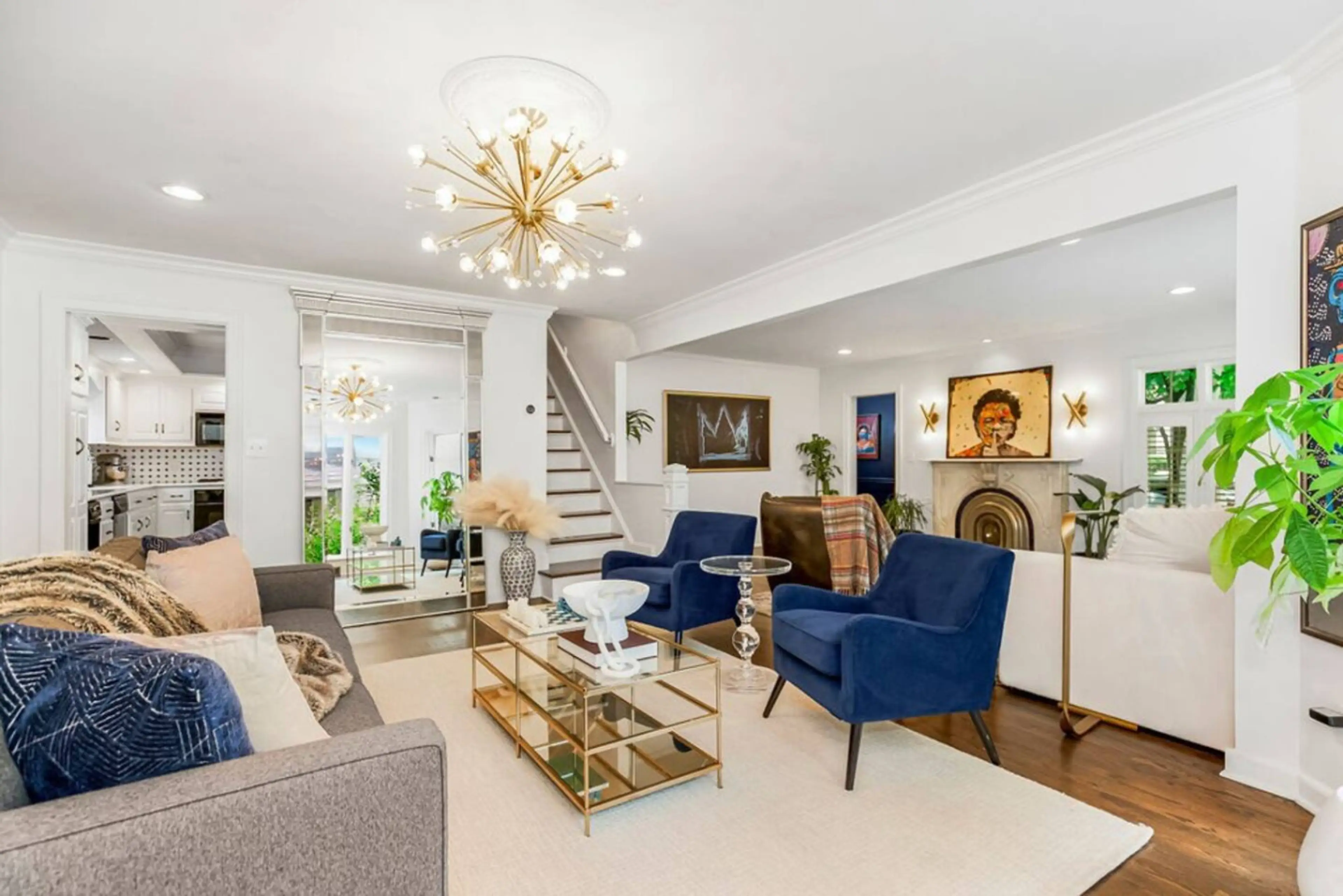Living Room: Vibrant artwork and chic furnishings create an inviting space for gathering and relaxation.