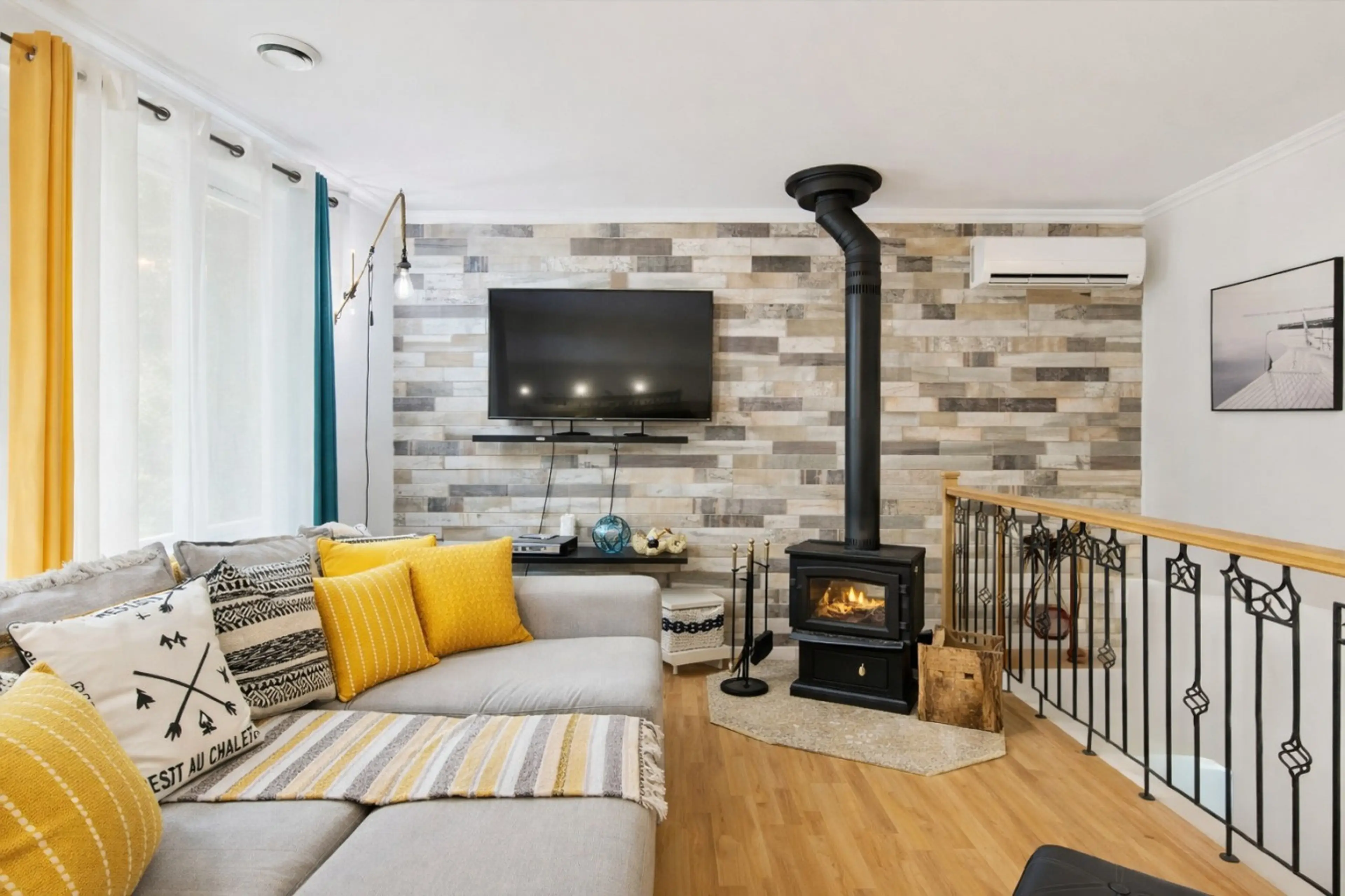 A bright living room with wood stove and a welcoming atmosphere.