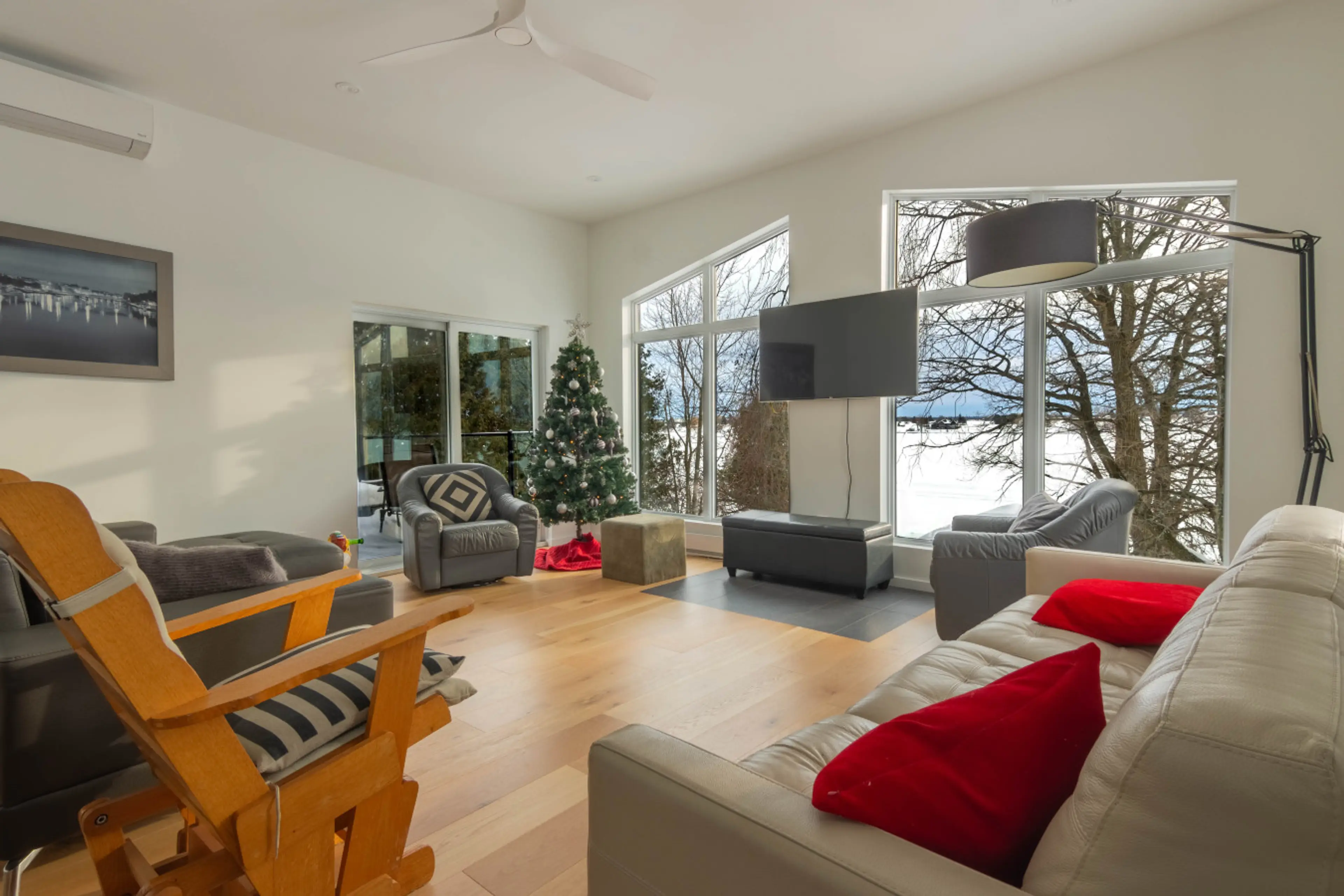 Spacious and bright living room with large windows and a cozy seating area