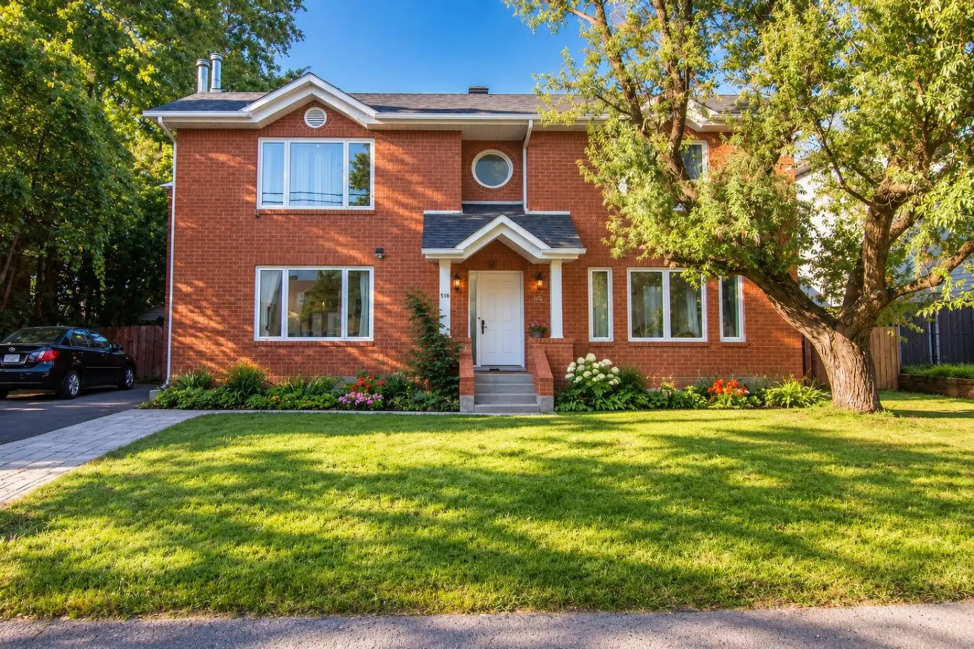 Welcoming brick home with a well-kept front exterior and private driveway.