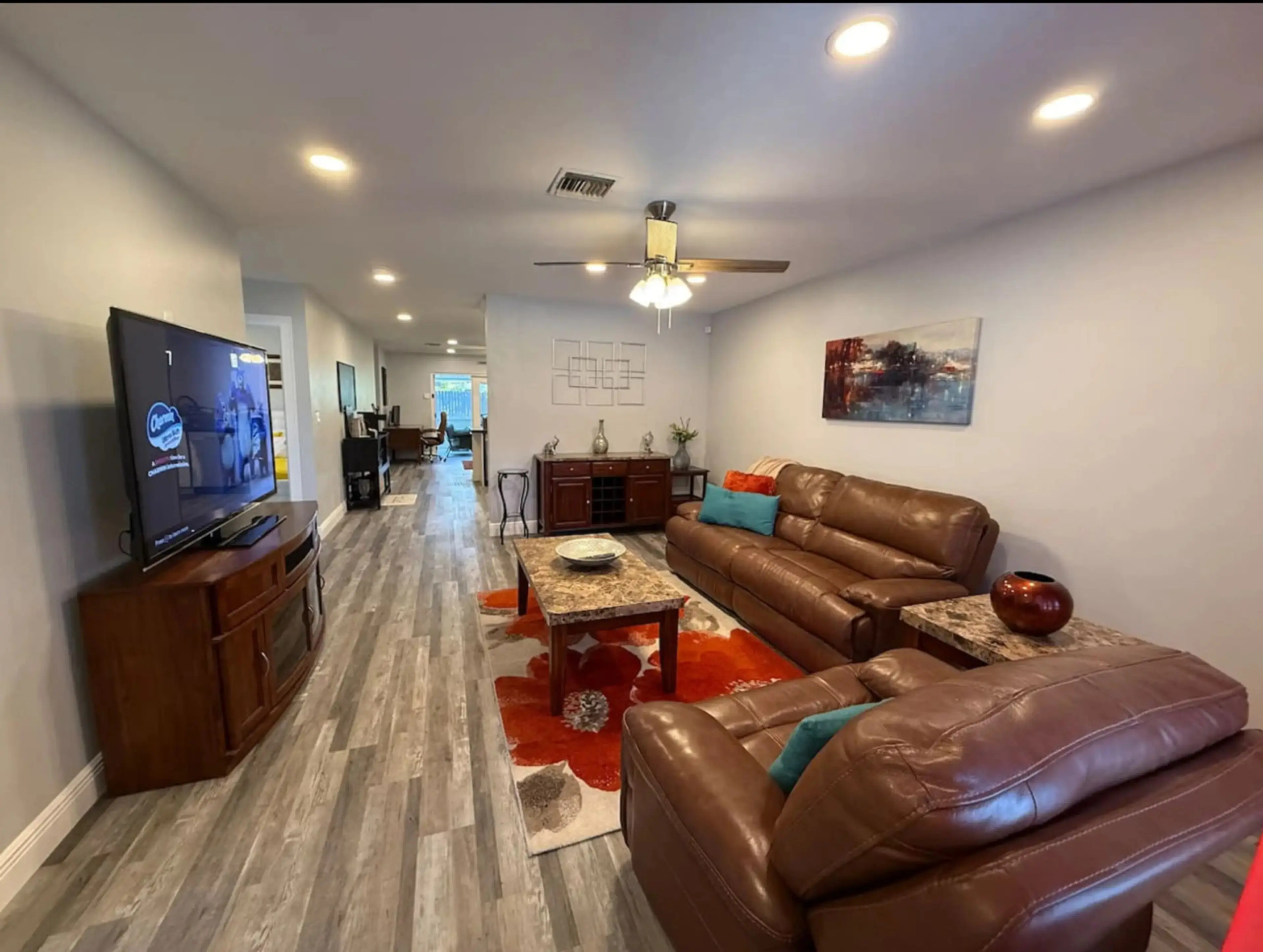 Spacious open-concept living room with smart TV and comfortable seating