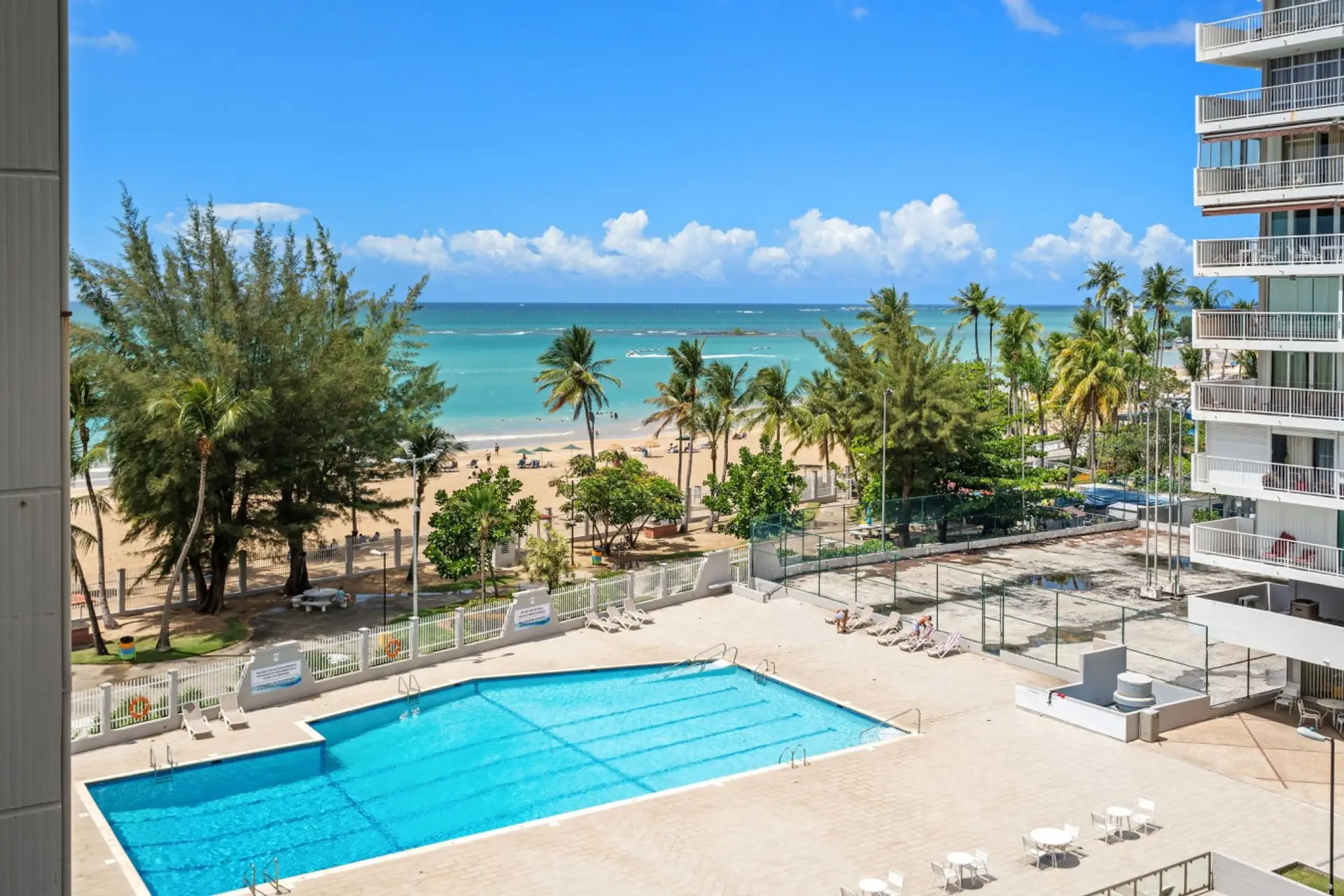 Aerial view of the building’s pool and direct beach access