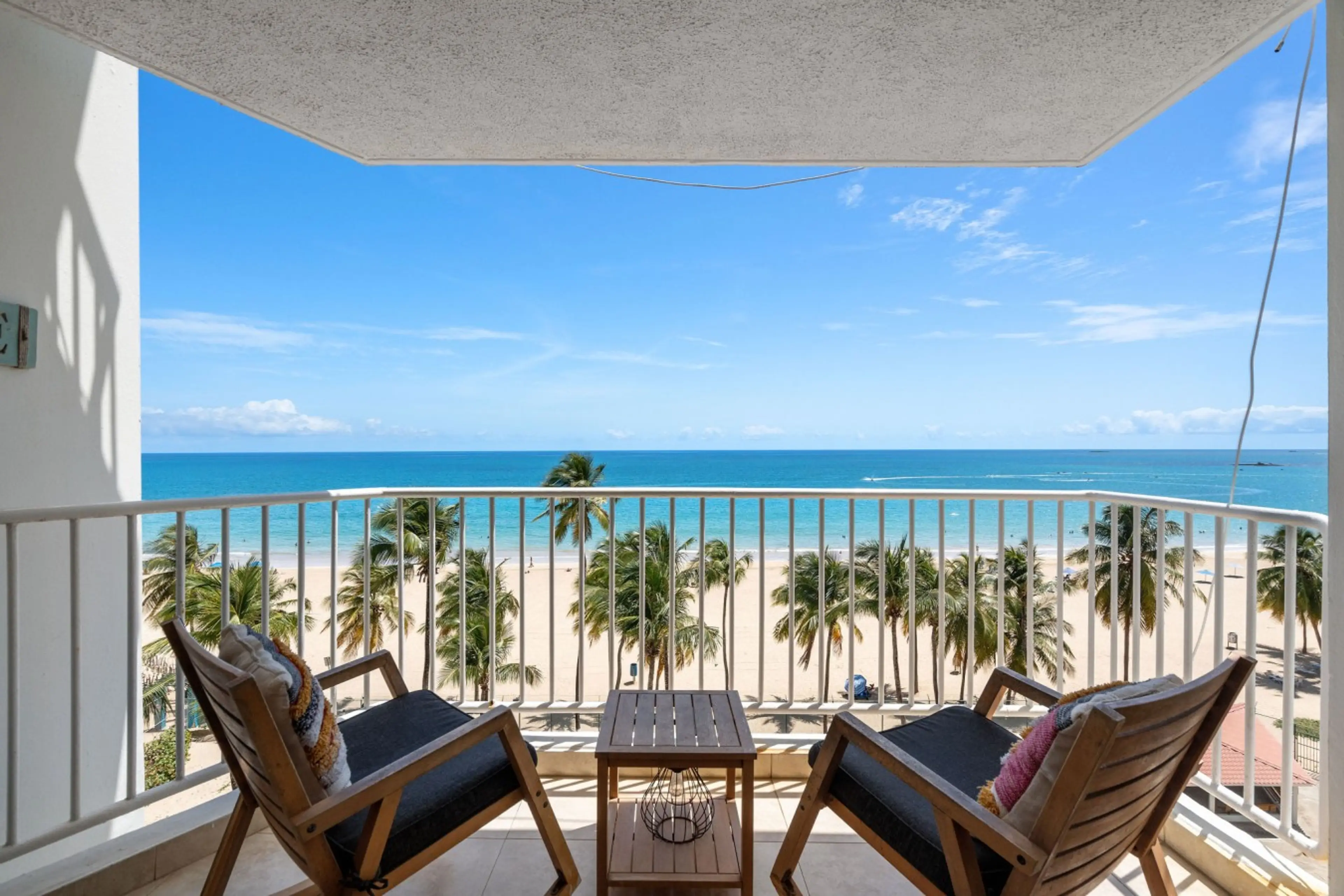 Private oceanfront balcony — the perfect spot for morning coffee or sunset drinks.
