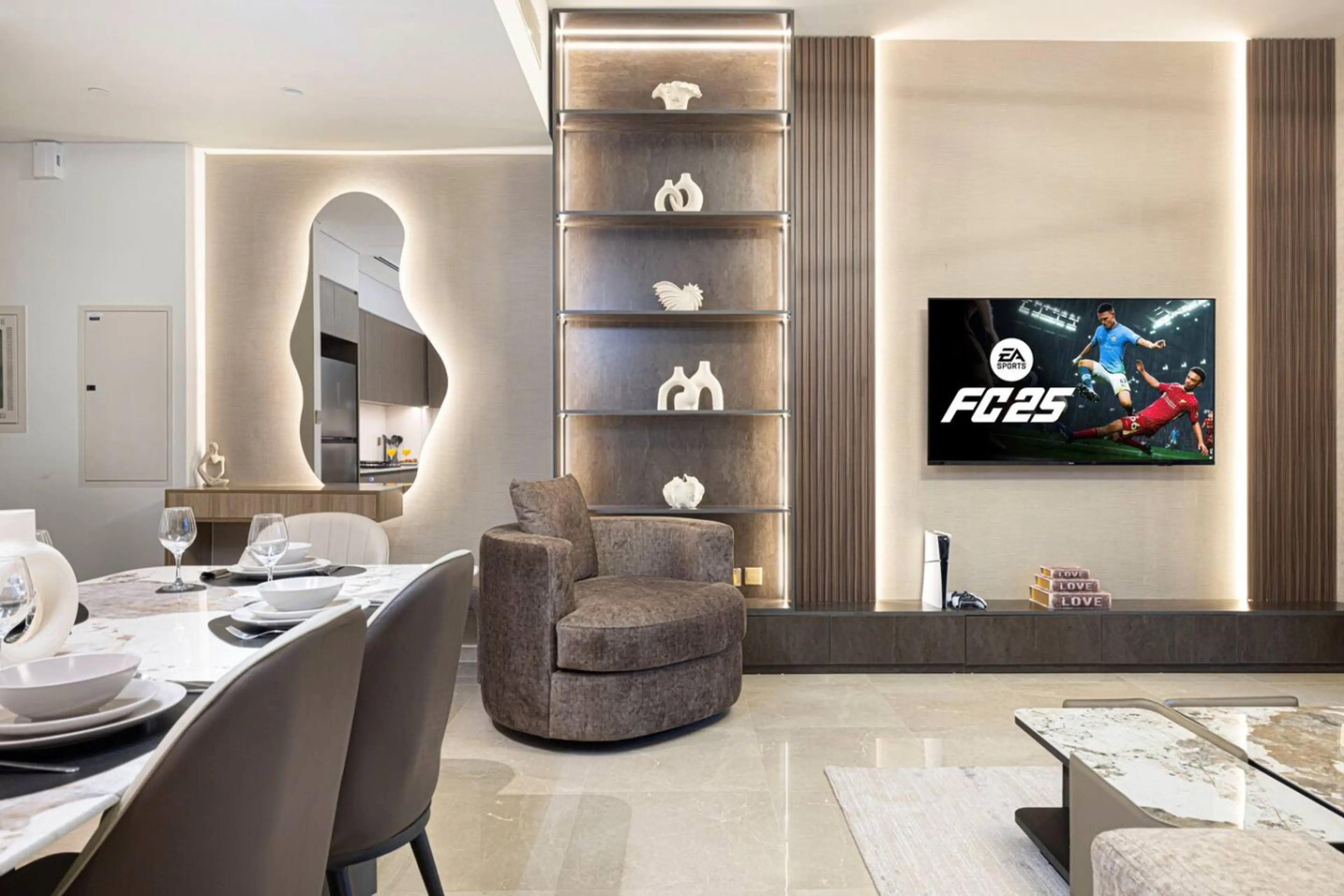 Enjoy a beautifully decorated living room featuring modern furnishings and elegant décor, seamlessly connected to a stylish dining table. This open-concept space offers comfort and sophistication for your luxurious stay in Downtown Dubai.