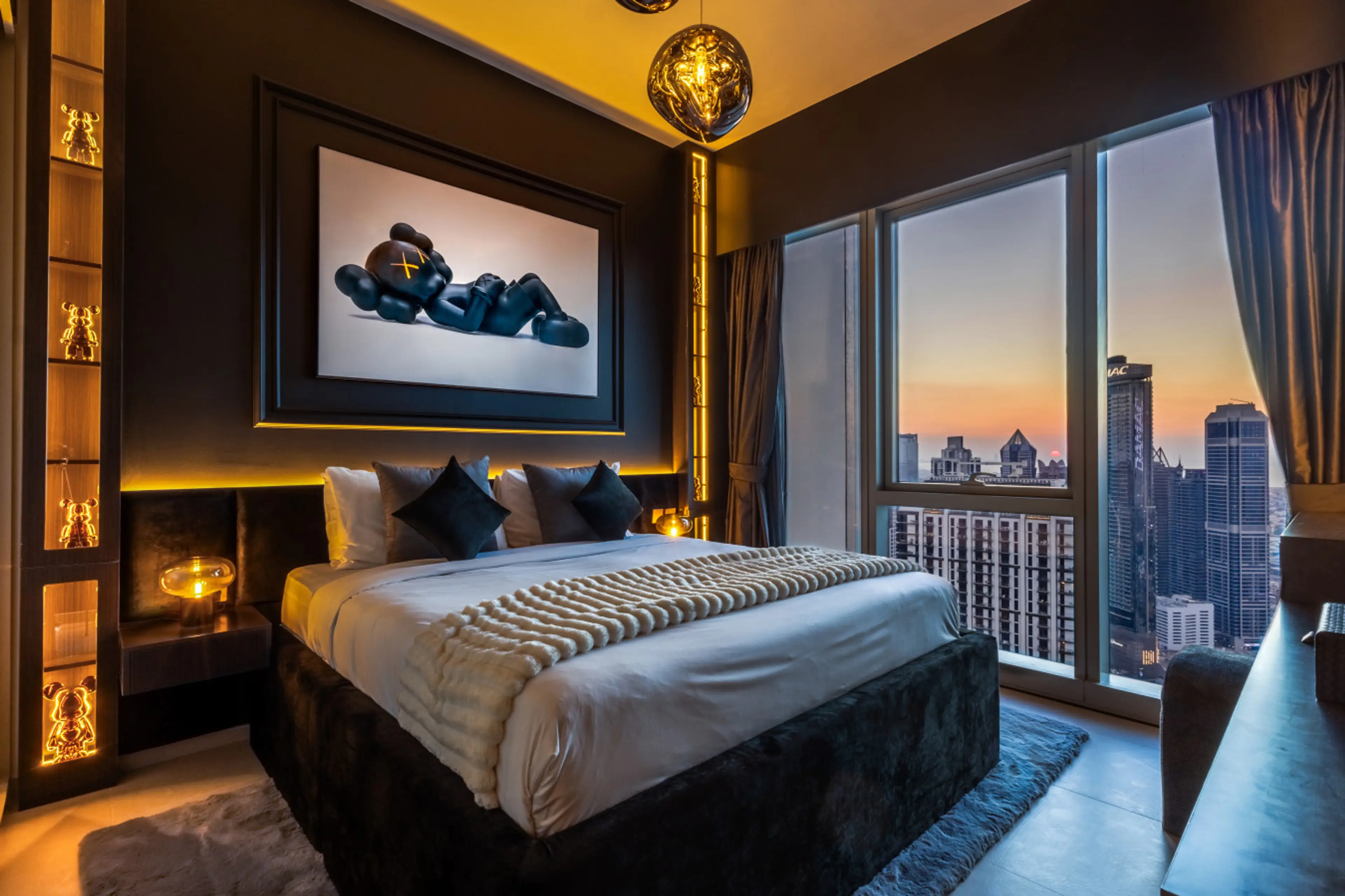 A luxurious bed adorned with plush cushions and elegant decor, set against stunning floor-to-ceiling windows showcasing breathtaking views of Downtown Dubai’s iconic skyline.